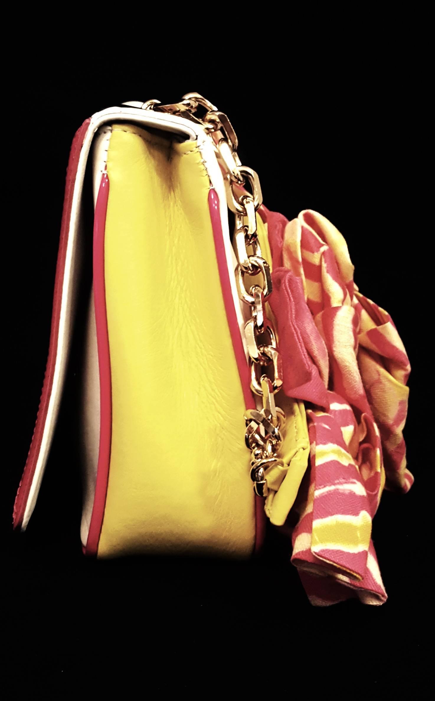 Christian Louboutin artemis papillote hot pink and yellow tie dye bows on the yellow leather & gold tone chain top handle strap is quirky and playful! Who wants to be serious when the sun is shining and the birds are singing, with the removable and