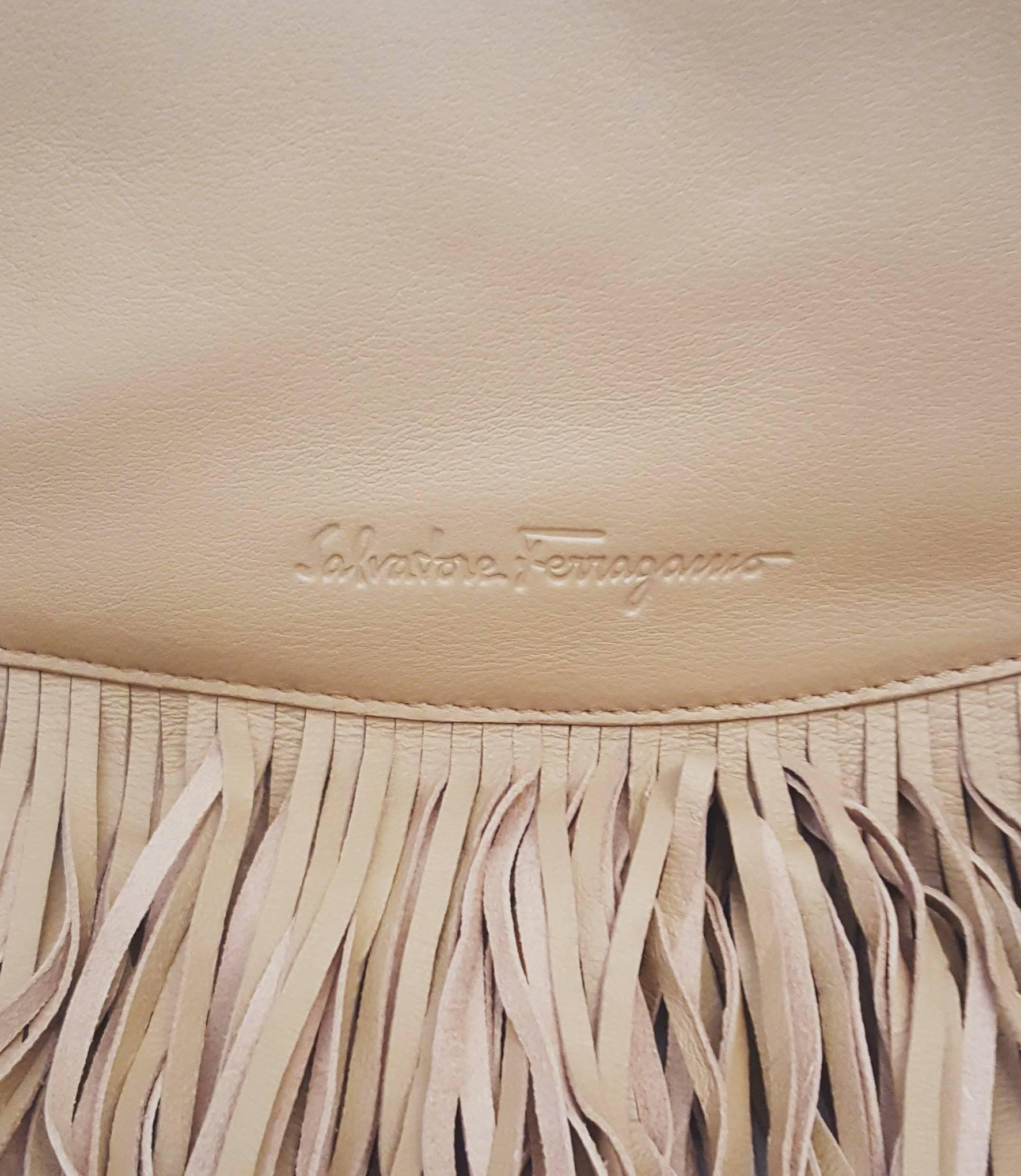 Salvatore Ferragamo tan leather Hobo with long soft leather fringe all around the tote creates a luscious fringe cascade border.  The braided metal chain and leather details are throughout the shoulder strap/handle and body of the bag. This bag is
