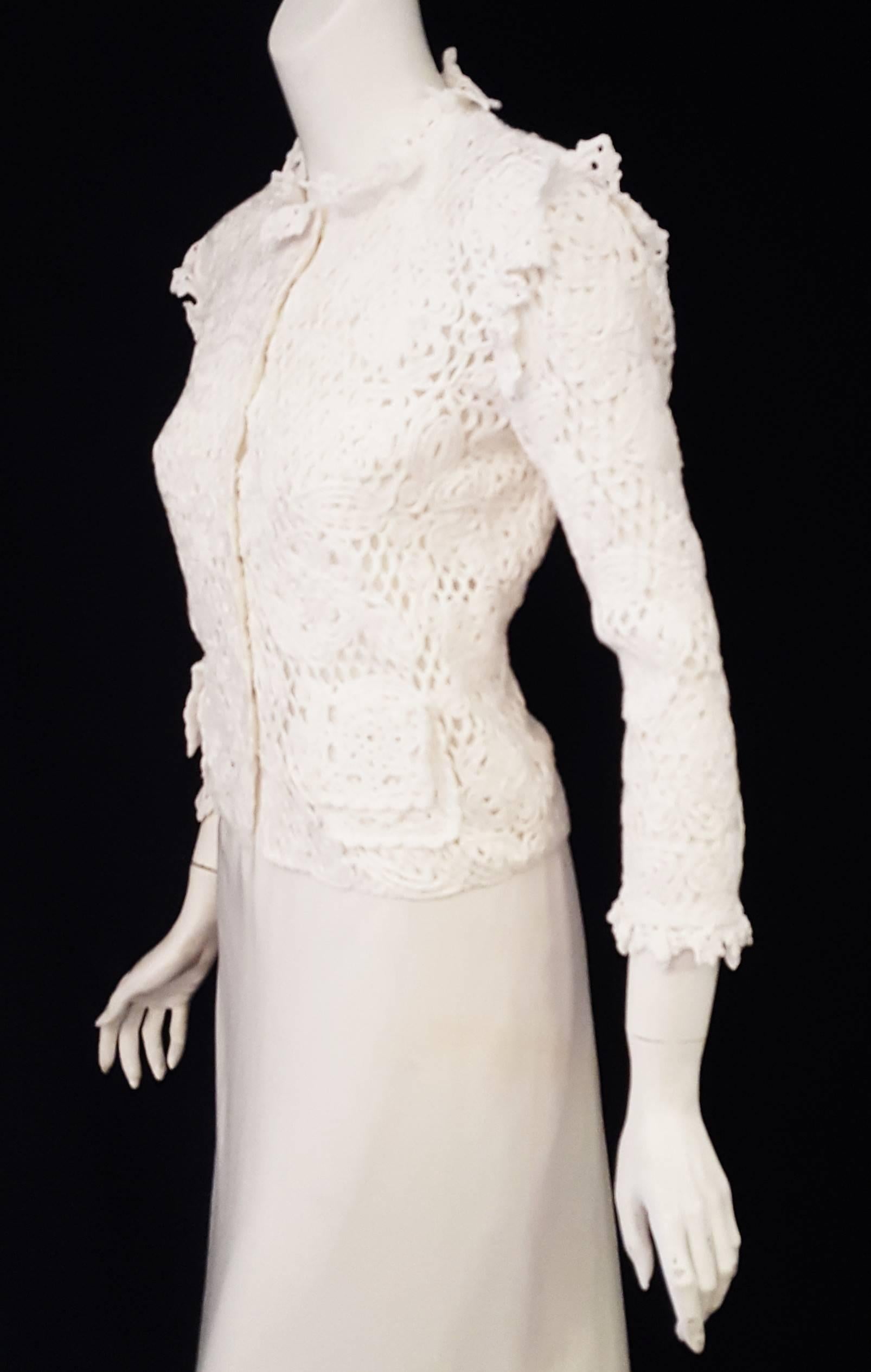 Dolce & Gabbana cropped white 100% cotton crochet jacket with a flower design throughout is a special edition piece from the 2011 spring/summer collection.  For closure, this jacket features 9 snaps at front.  This garment highlights the romanticism