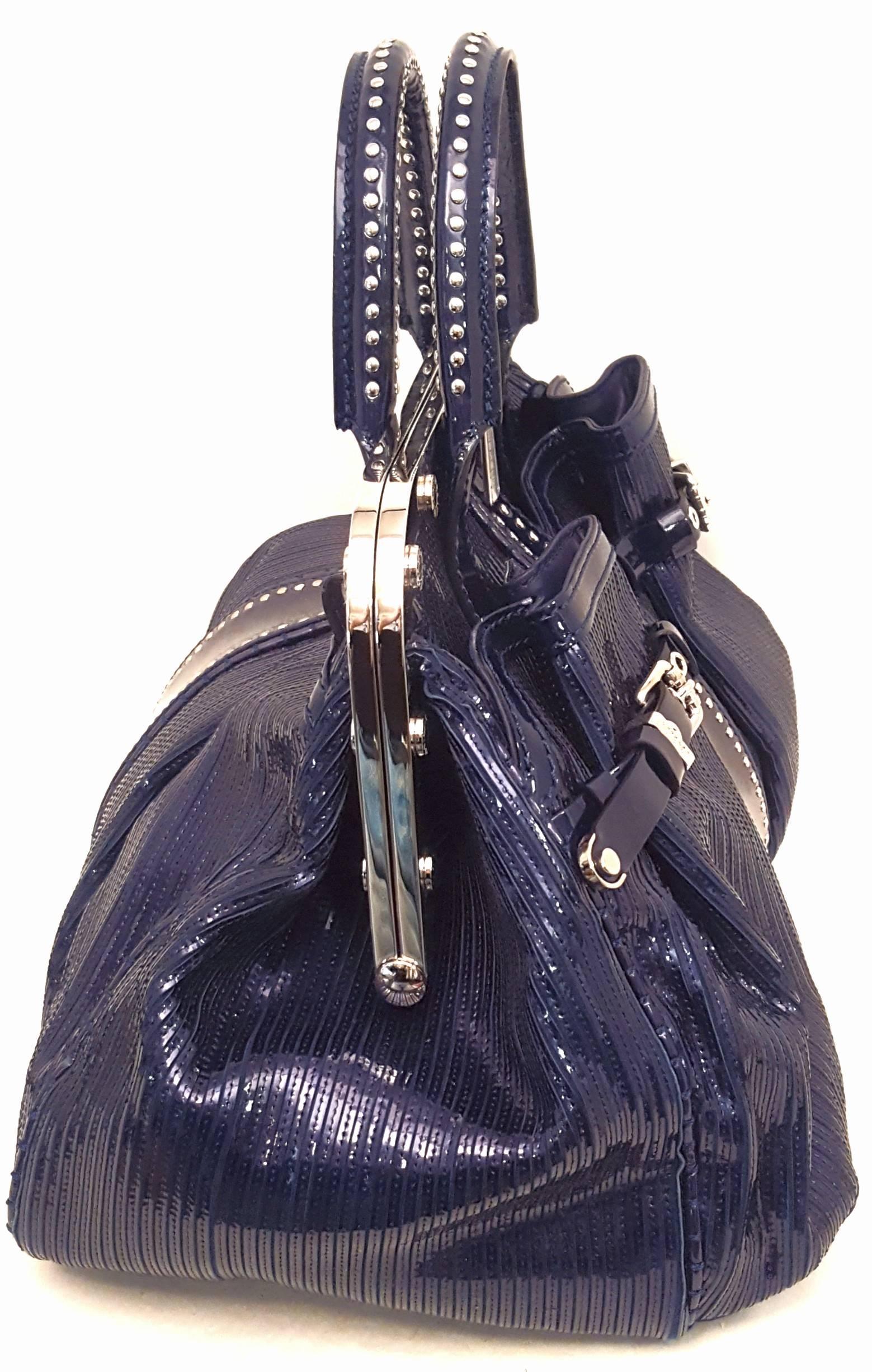 Versace limited edition blue Glitz patent leather satchel with two top handles and removable shoulder strap is so fashionably consistent with the Versace criteria!  This satchel features its silvertone hardware on the top handle mini studs, on the