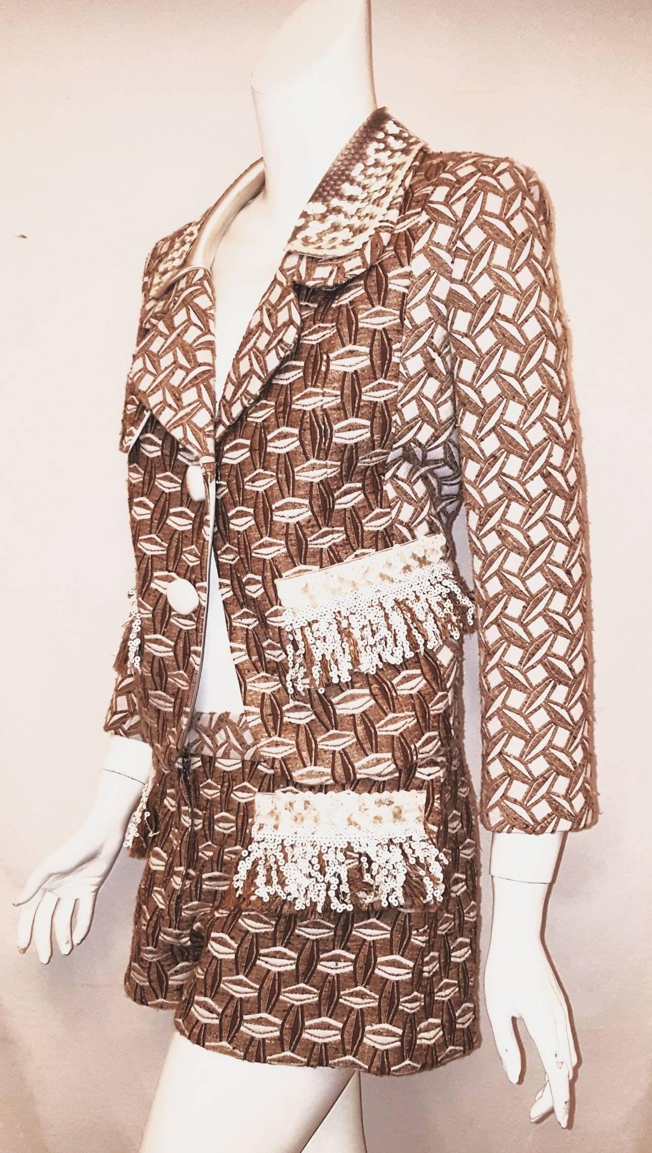 Louis Vuitton 3-piece suit includes a cocktail dress, a long sleeve jacket and a pair of shorts, that can be mixed and matched to create your own ensemble.  This 3 piece suit is composed of a cocktail dress that comes in a tan and white embroidered