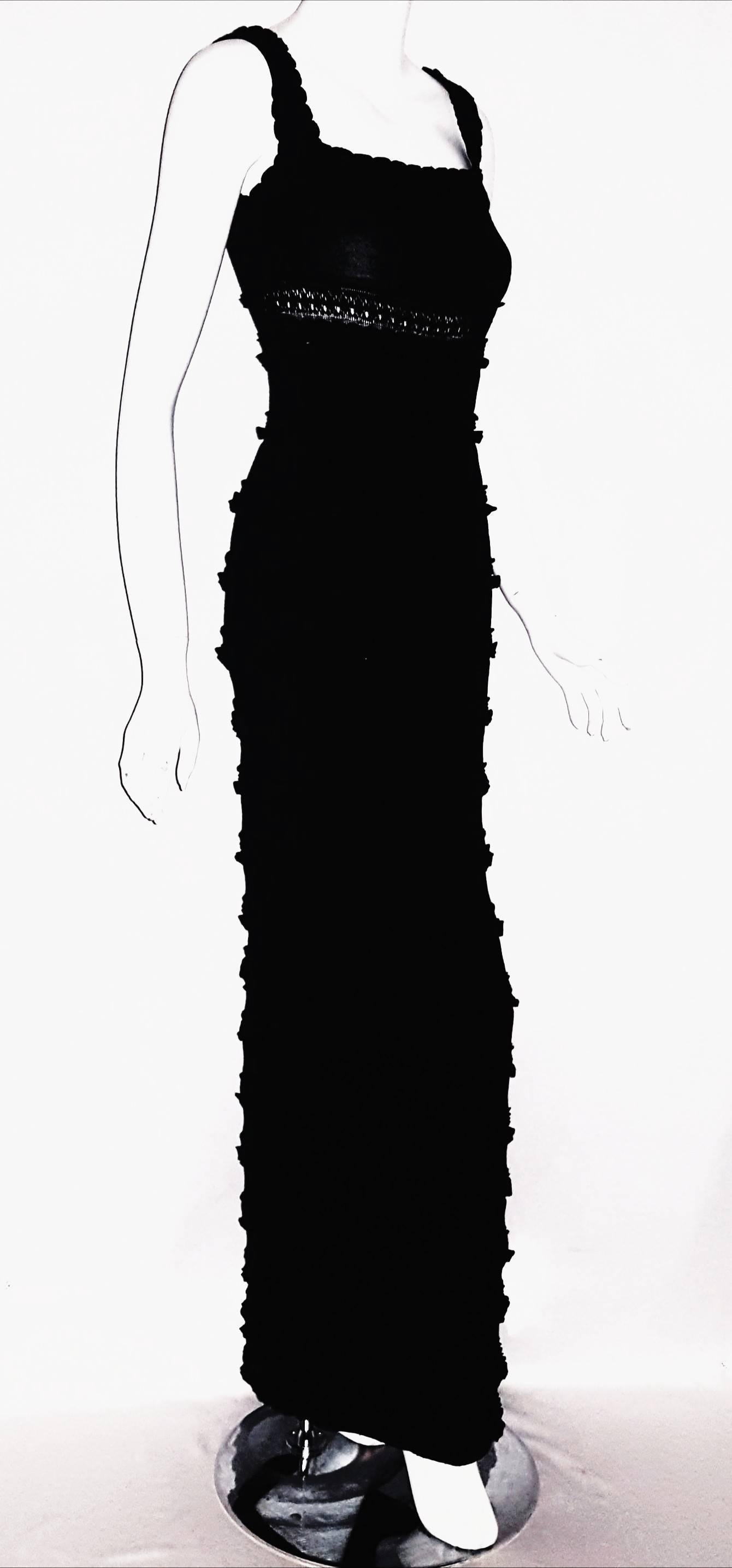 Sleeveless Alaia black wool knit bodycon dress with ribbed trim around square cut neckline and shoulders was a hit on the Runway!  This long dress has tiered mini ruffle bands alternating with gathered strips from the bust line down to the hem. 