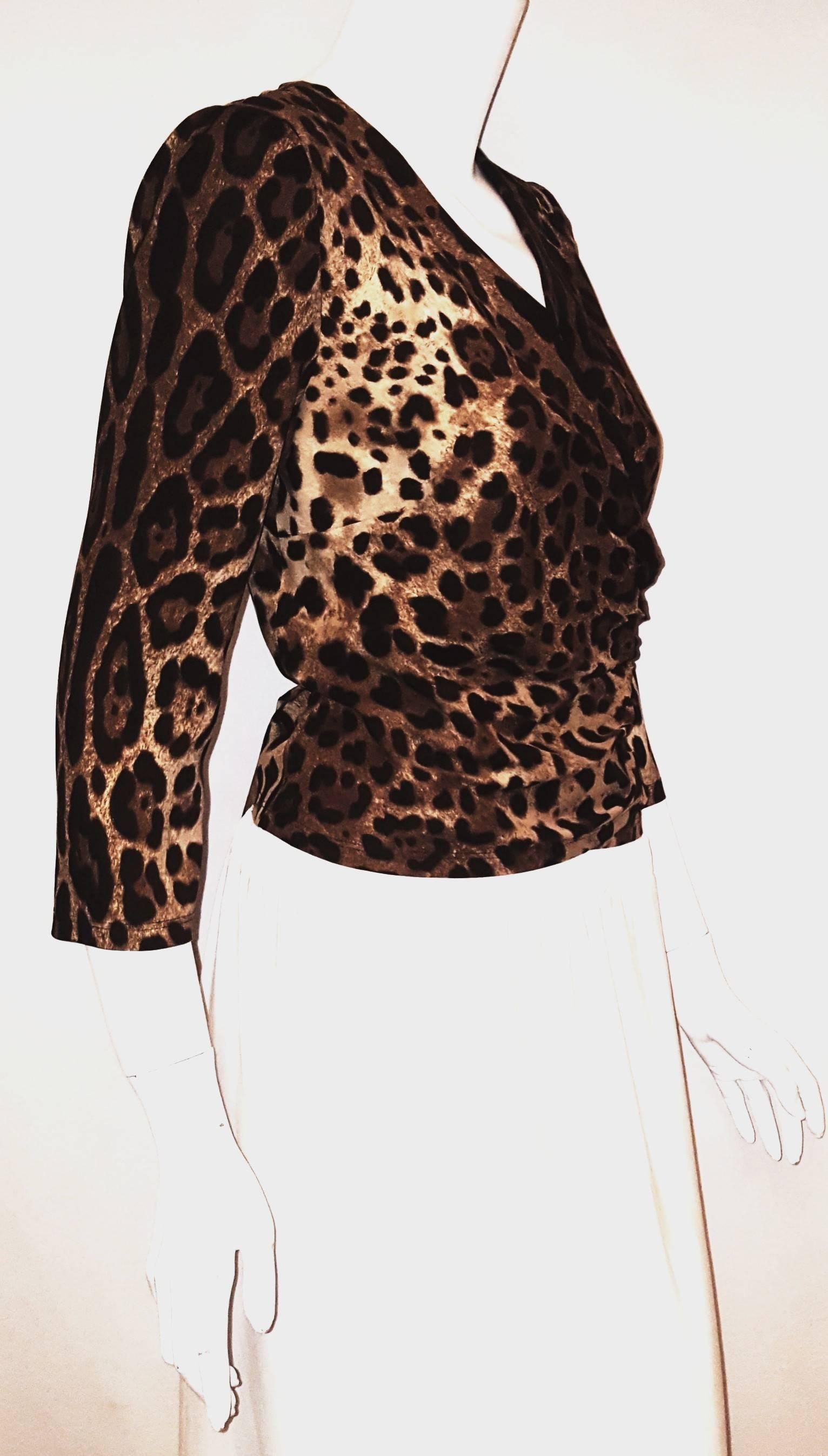 Dolce & Gabbana silk leopard print in brown and beige hues wrap blouse with 3/4 sleeves and v neckline is casual but easy transforms to evening when paired with the right accessories, skirt or pants!  For closure there are long adjustable sashes