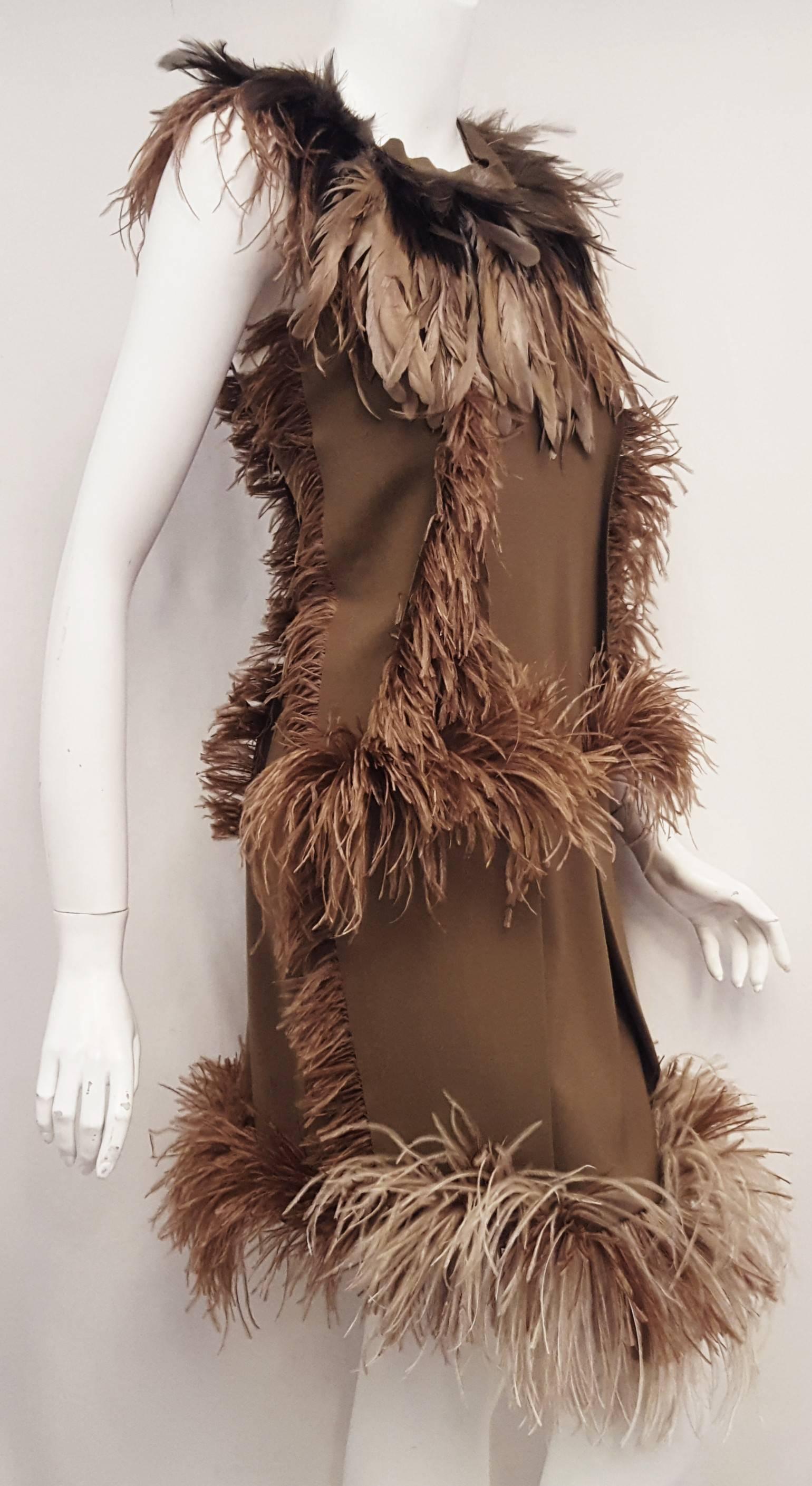Lanvin's ostrich feather Hiver/Winter 2010 runway dress with claudine or round collar is created totally inside out.  Sleeveless dress has all the seams on the outside with the excess fabric on display.  Even the zipper is showing in this whimsical