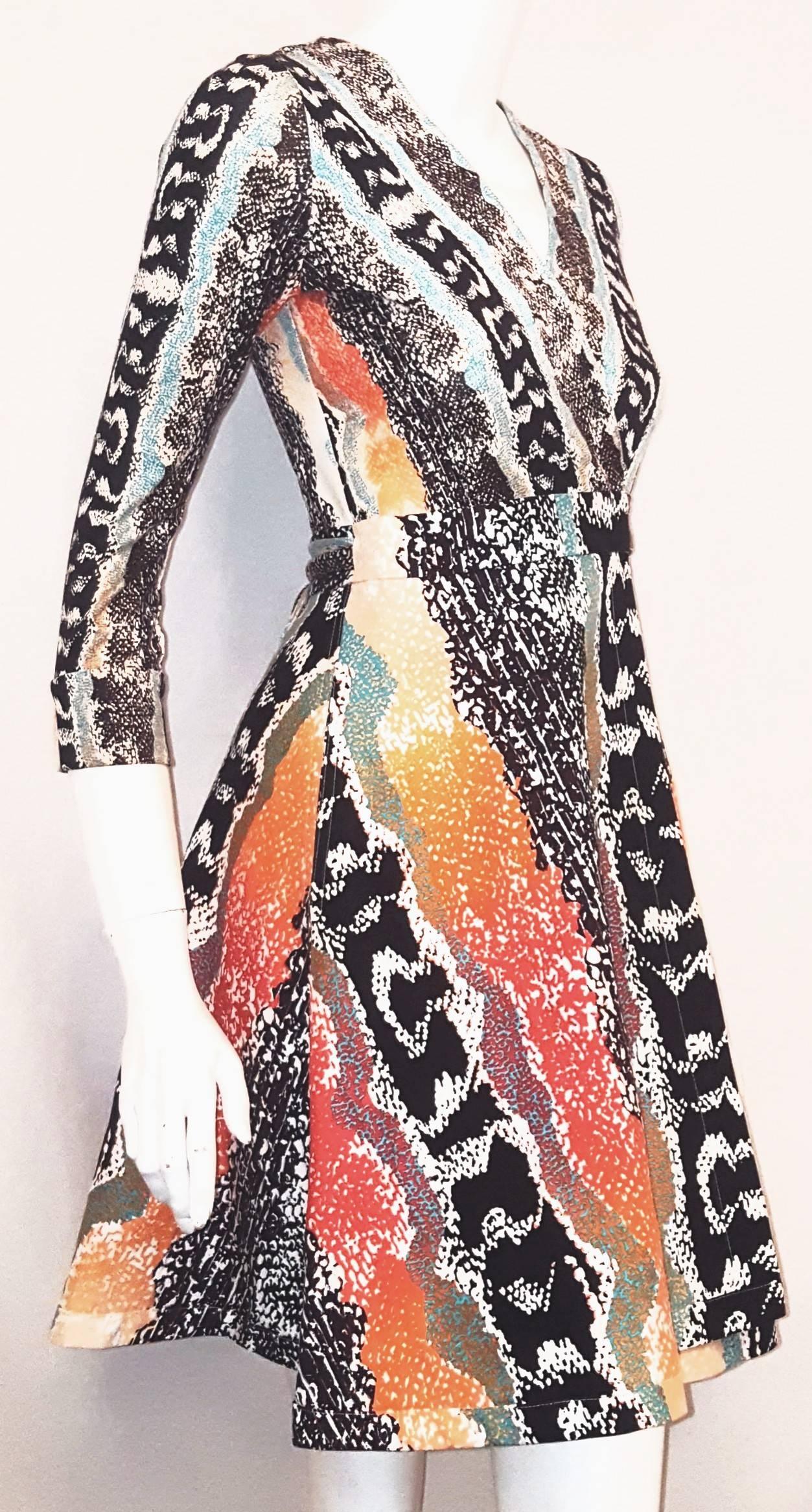 Diane von Furstenberg classic wrap dress in bright orange, turquoise, brown, black, red and white abstract print dress would be a constant complement to any wardrobe for the summer season, practical and easy to accessorize.  This dress contains 2