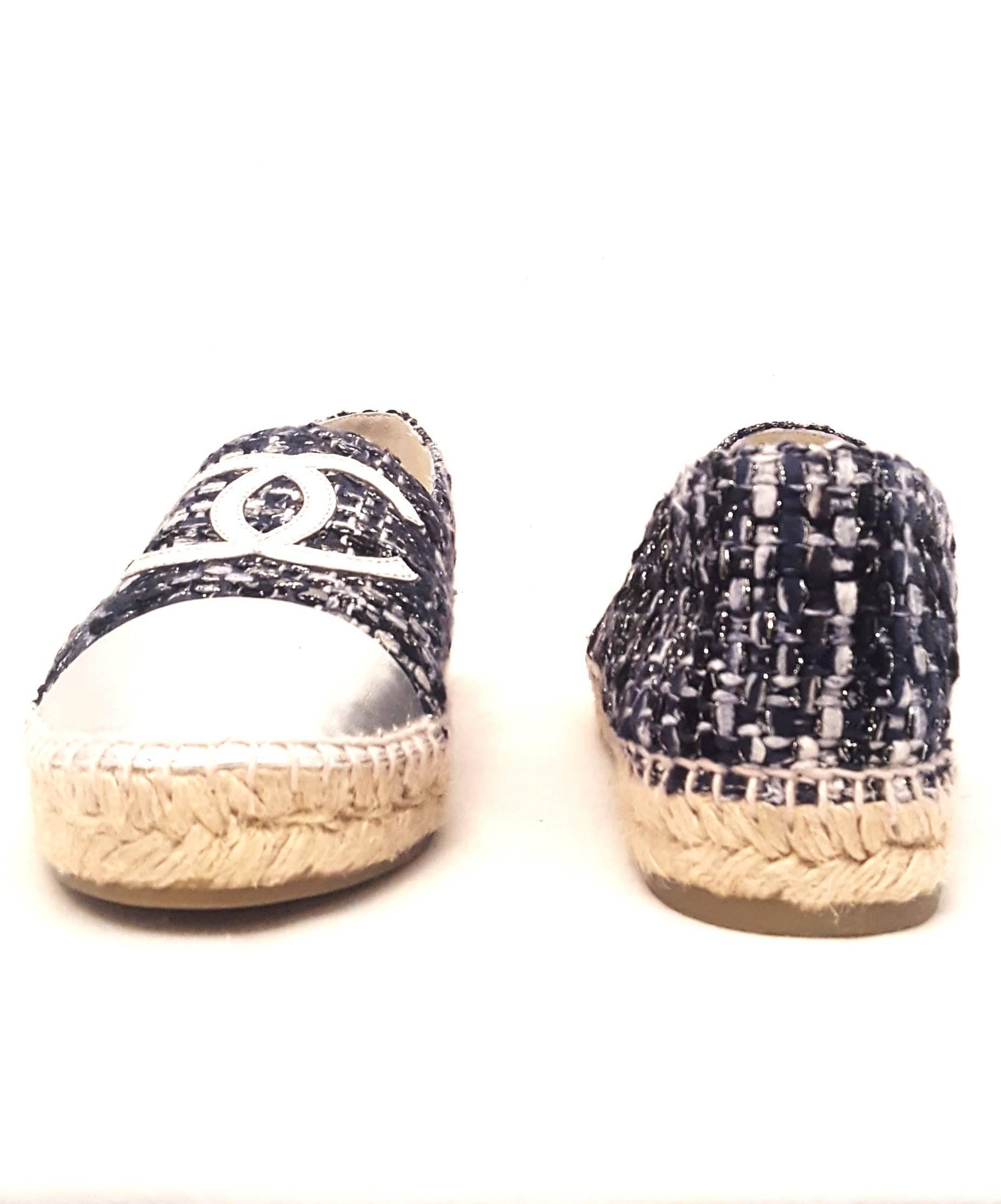 Chanel navy and grey tweed with silver metallic leather cap toe espadrilles are perfect for summer!  These espadrilles are fully lined in ivory leather including the inner soles. The iconic rope trim can be found all around the shoe.  The soles are