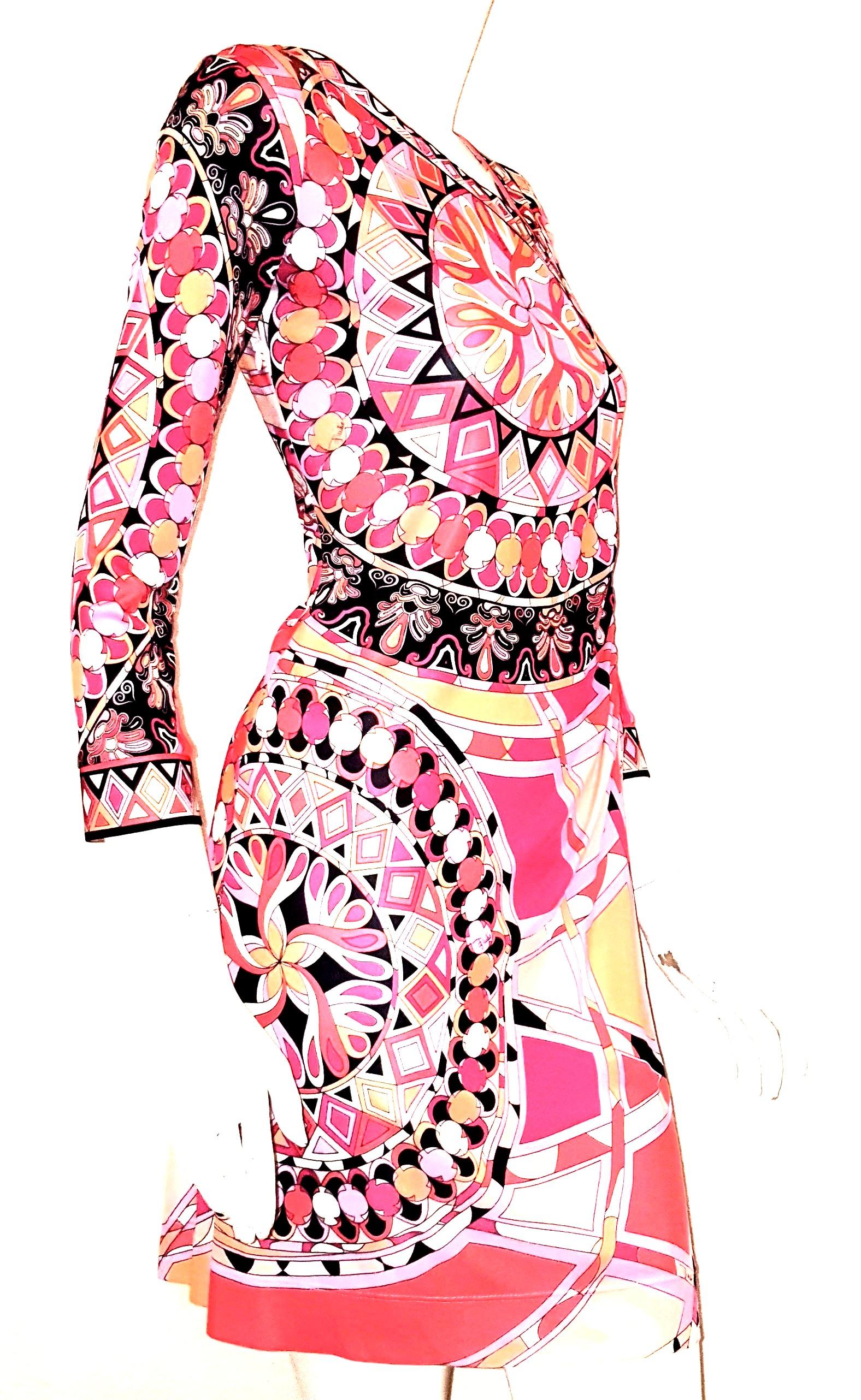 Emilio Pucci pink abstract print dress is gathered at the waistline to further accentuate the waist.  This dress has an asymmetric V neckline with the accent to the left of the dress, as well as the loose folds around the waistline.  The 3/4 sleeves