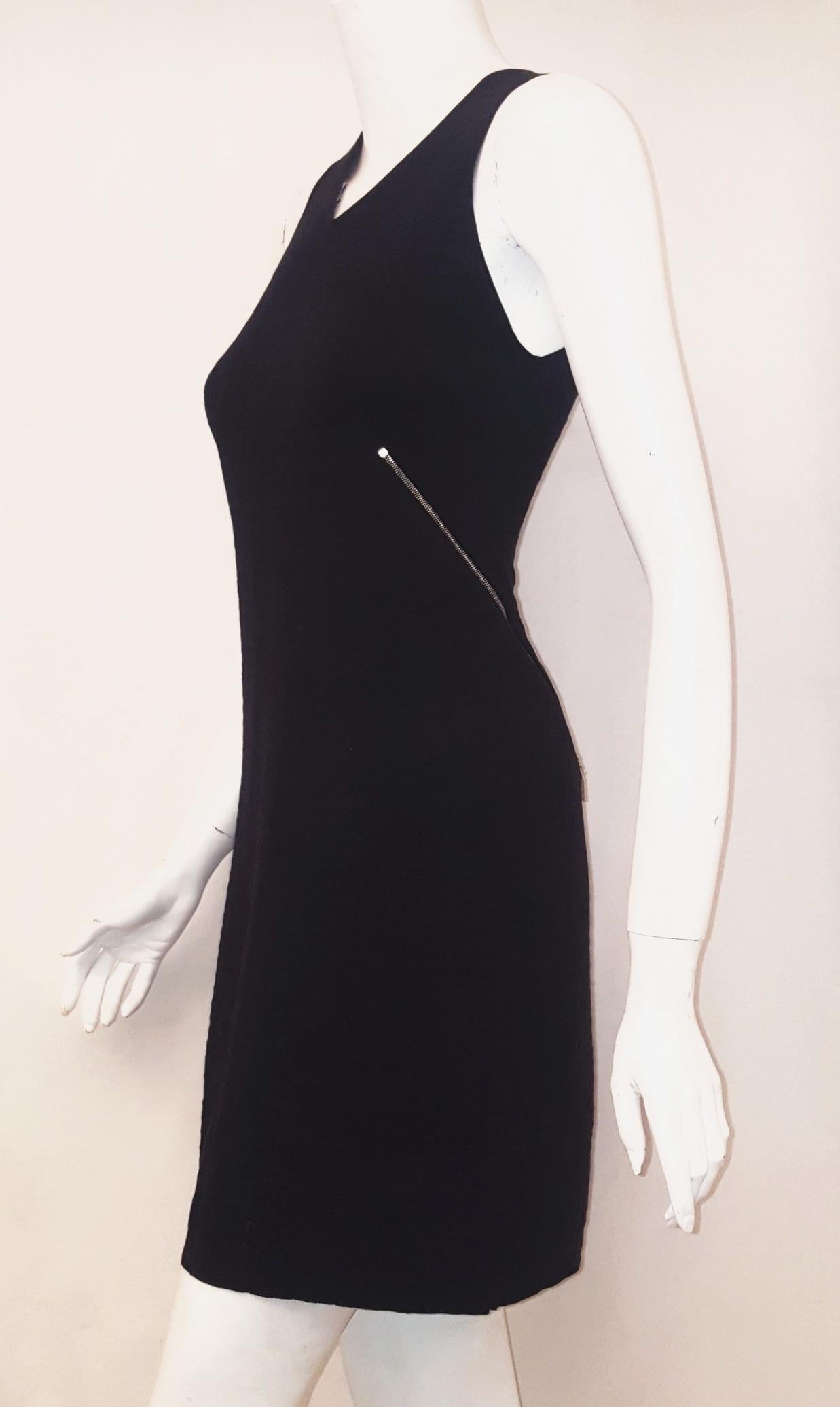 Chanel black sleeveless pullover cotton dress embellished with 4 gold tone CC zippers at front and back.  This modern V neck beauty can be dressed up with a cashmere stole and large gold earrings. Or worn for any LBD occasion!  This cotton dress