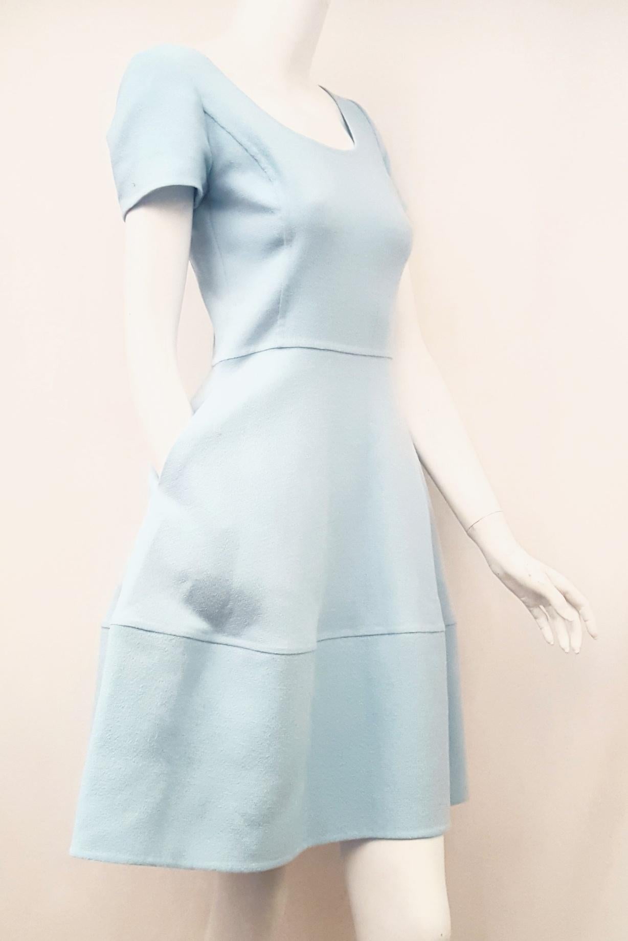 Oscar de la Renta short sleeve A-line dress with fitted waist is a casual yet elegant dress.  With scoop neckline and textured pattern throughout, this dress is the perfect travel companion.  Two side slit pockets for completes the flirty look of