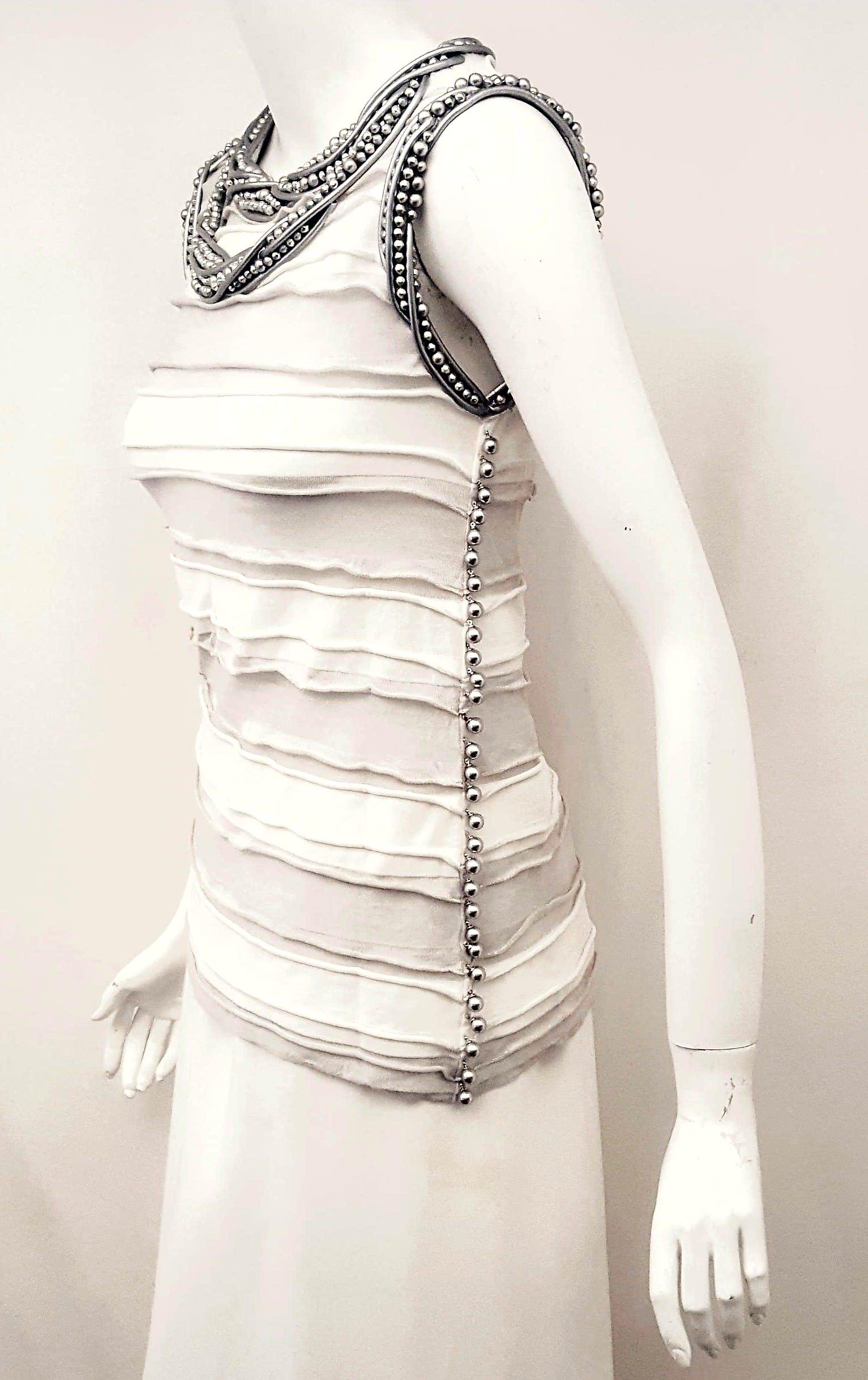 Chanel white and grey knitted ruch top artistically decorated around neckline and arm hole with a double imitation necklace created with silver tone faux pearls and silver leather cords.  The ruching alternating with the grey and white bands forms a
