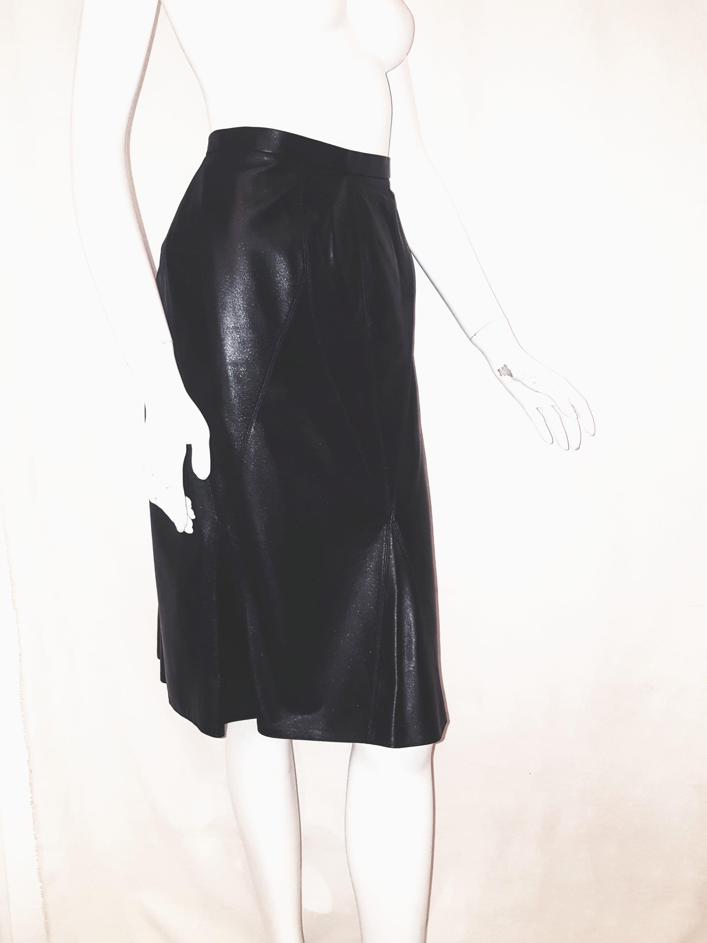 Chanel black buttery soft leather skirt from the Fall 2002 collection,  features a stitched yoke style waistband with double stitching seams down the front creating an asymmetrical ruffle around the hem.  A small Chanel metal tag is located on the