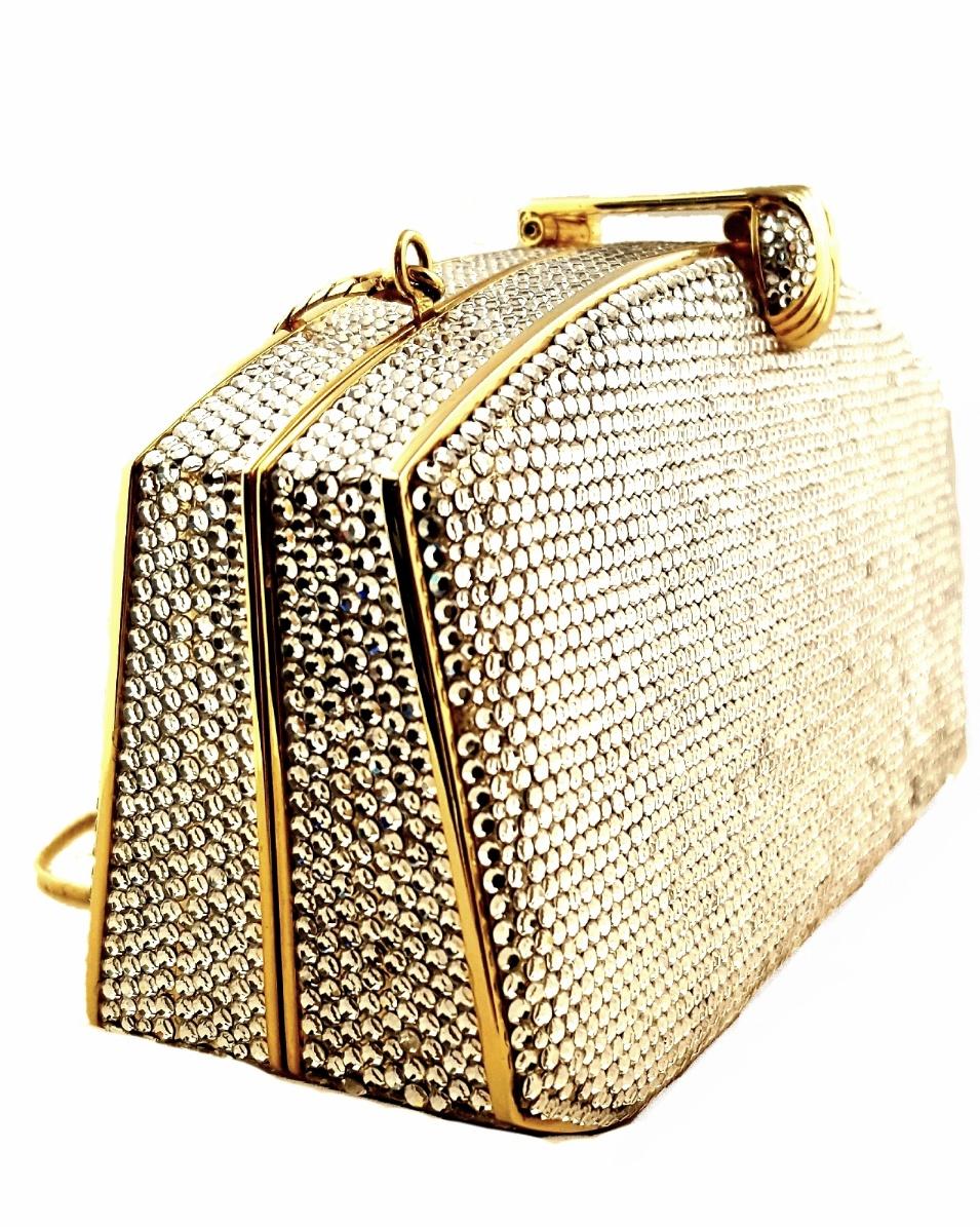 Judith Leiber clear silver tone Swarovski crystal Minaudiere evening bag classic clutch is in excellent condition. Clear swarovski crystal exterior is set over a gold solid form body. Top embellished crystal and metal closure opens to a metallic