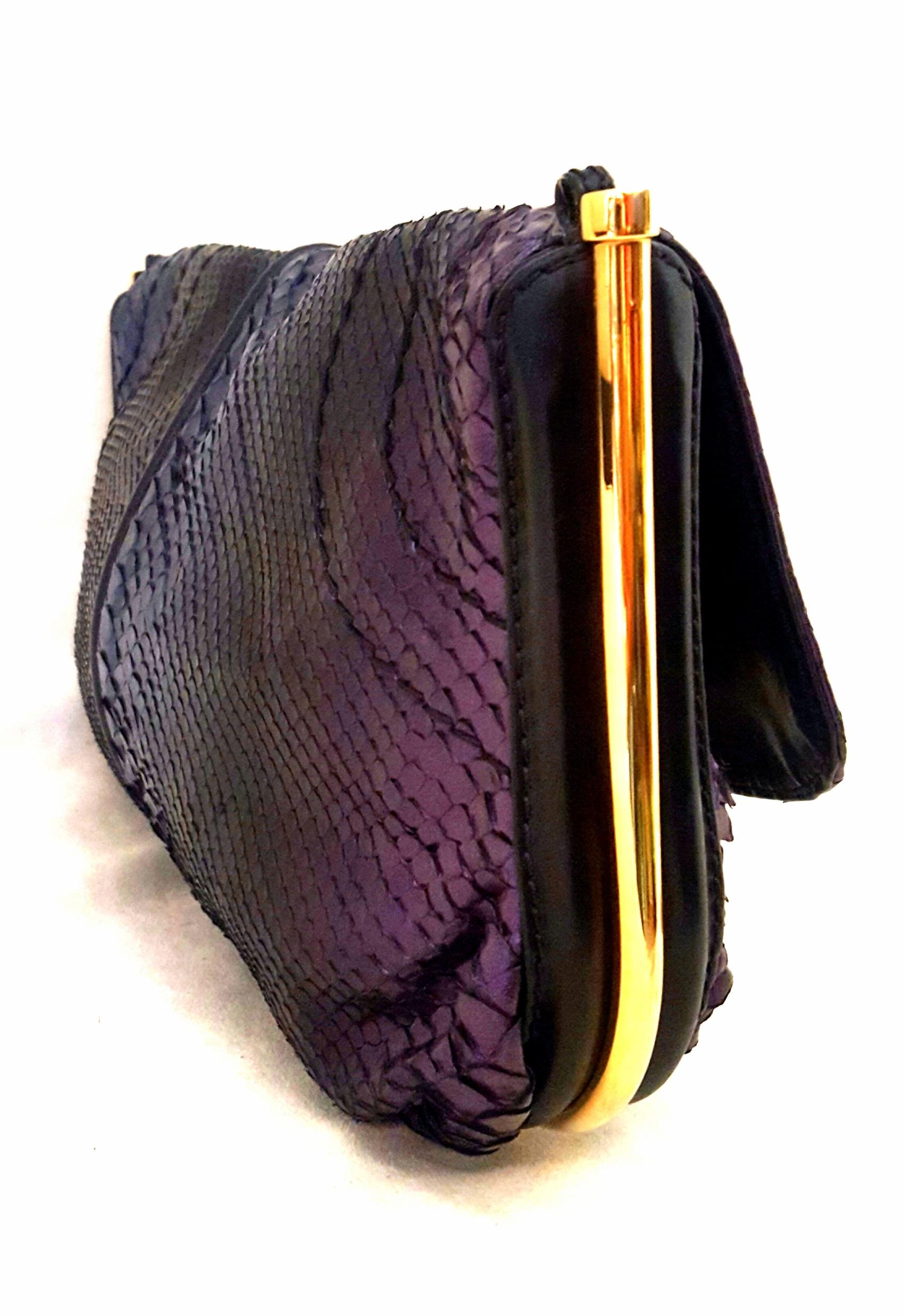 Jimmy Choo blue and purple ombre effect metallic python shoulder bag is dramatically accentuated with multiple decorations throughout. This bag features gold tone hardware, that includes the chain link shoulder strap and the contouring metal rods
