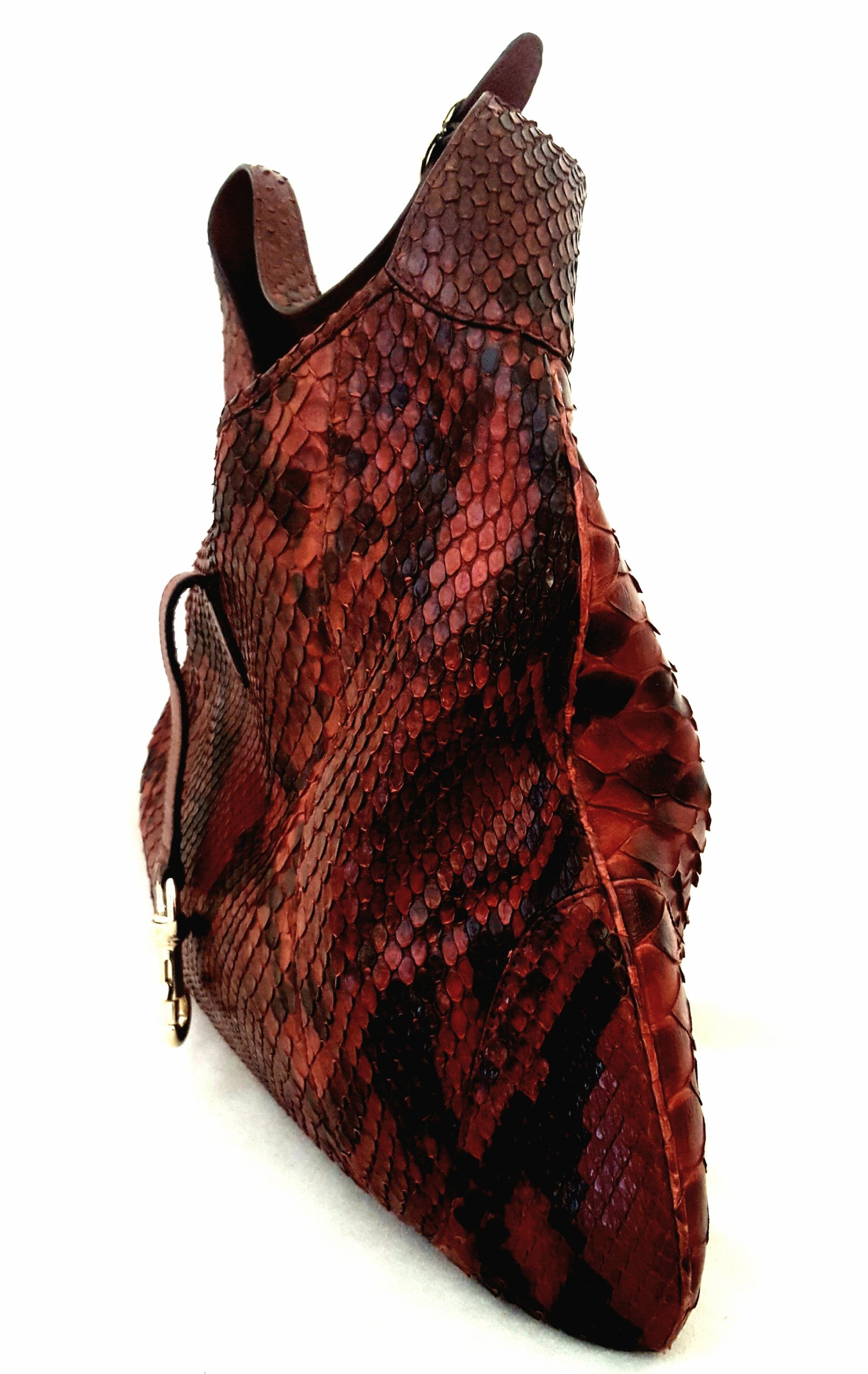 Gucci Jackie burgundy python leather hobo bag is in excellent condition.  It has a beautiful Python patterning at both front and back with burgundy and rust tones.  This bag was named for Jackie Kennedy Onassis.  In 1964 Gucci officially renamed the