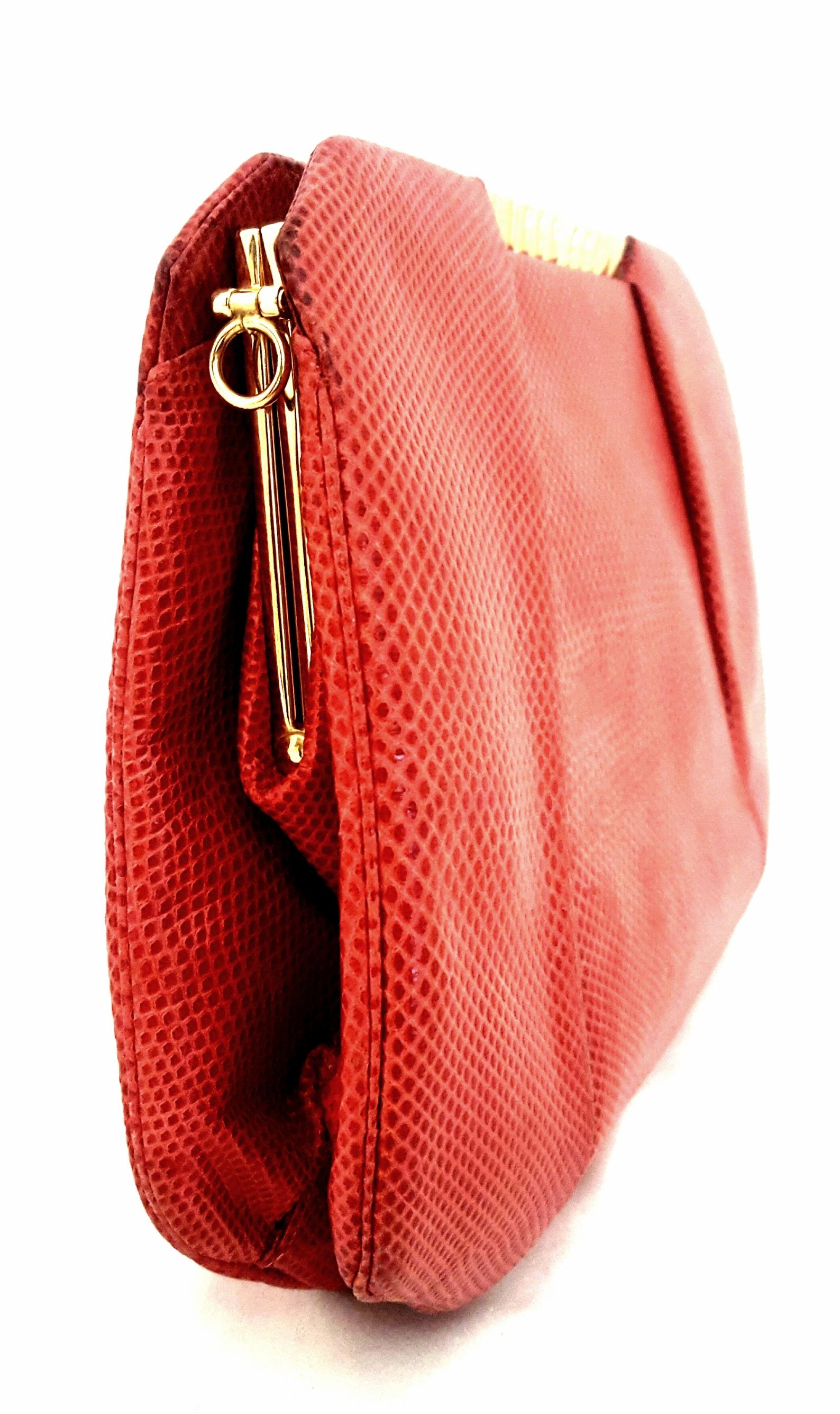 Judith Leiber 1970's vintage red Karung snakeskin bag. This bag is in good condition with minor wear on the bottom consistent with its age. It comes with a dust bag and coin purse. This beautiful bag has ribbed gold tone clasp.  Bag is lined in red