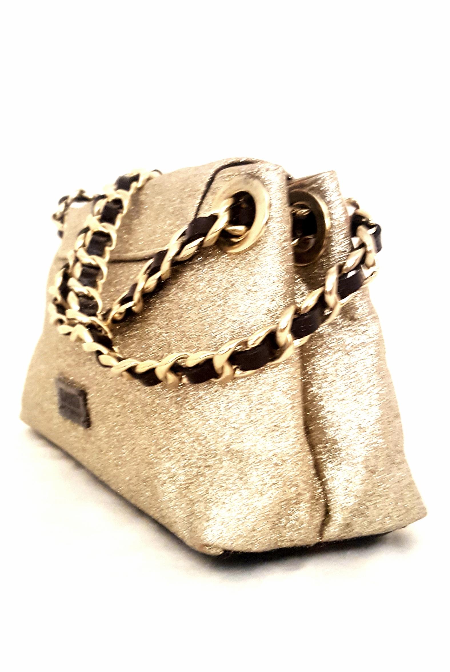 Moschino gold tone glitter leather bag with chain link and black leather threaded shoulder strap is perfect for both day and evening.   The interior is lined in gold tone satin divided in 2 pockets separated by center zippered pocket and a smaller