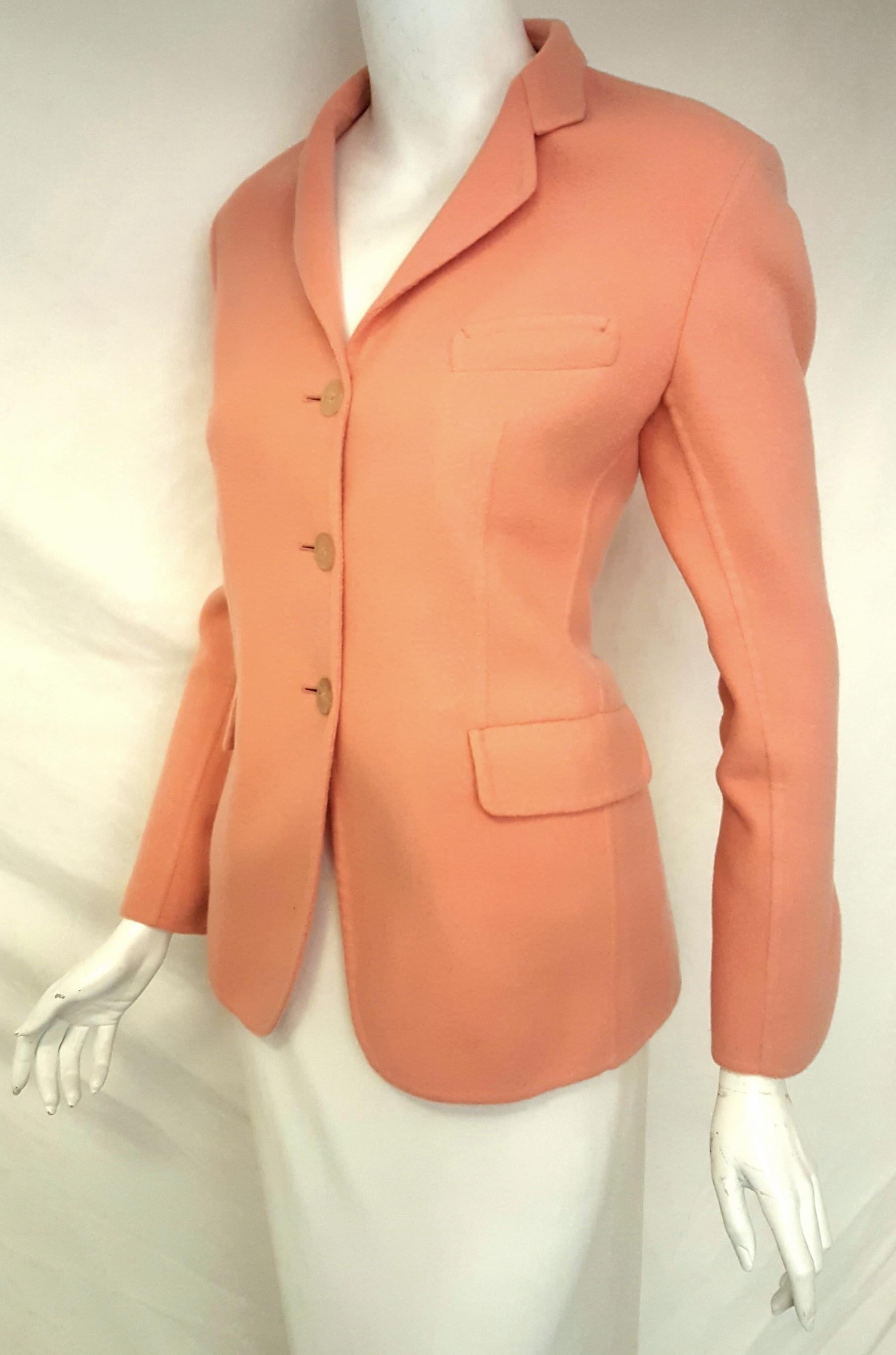 Jil Sander pink salmon cashmere single breasted jacket features a 3 button front closure.   This notch collar blazer has two flap pockets and one faux top pocket.  The jacket is only lined at shoulders and partial top front of jacket.  The sleeves