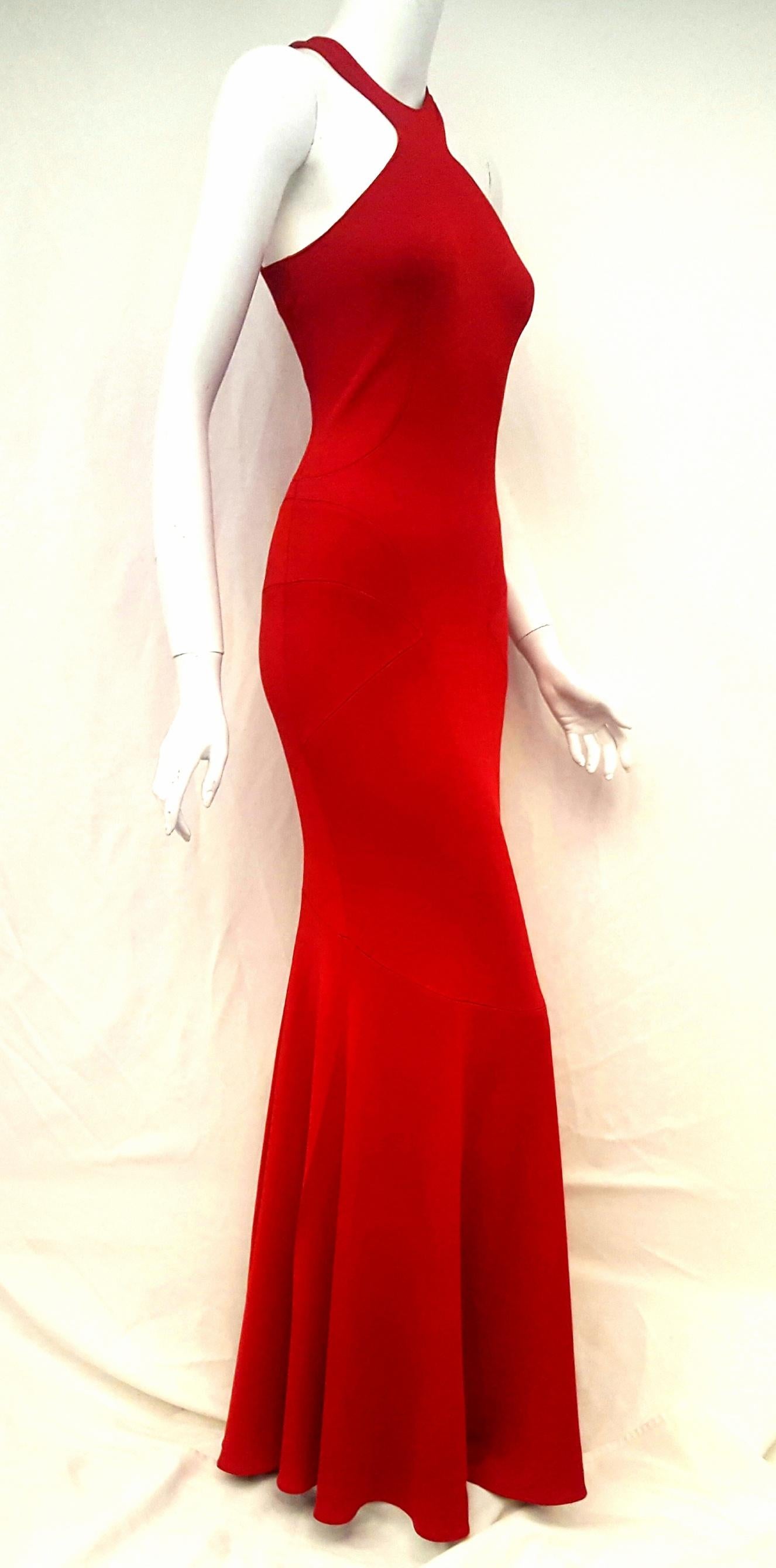 Alaia bodycon red viscose open ladder stitch at seams, showing a little skin and then some.  This dress finishes with a slight flare at the hem creating a floating effect as you walk.  Round high collar sleeveless with long zipper, at back for
