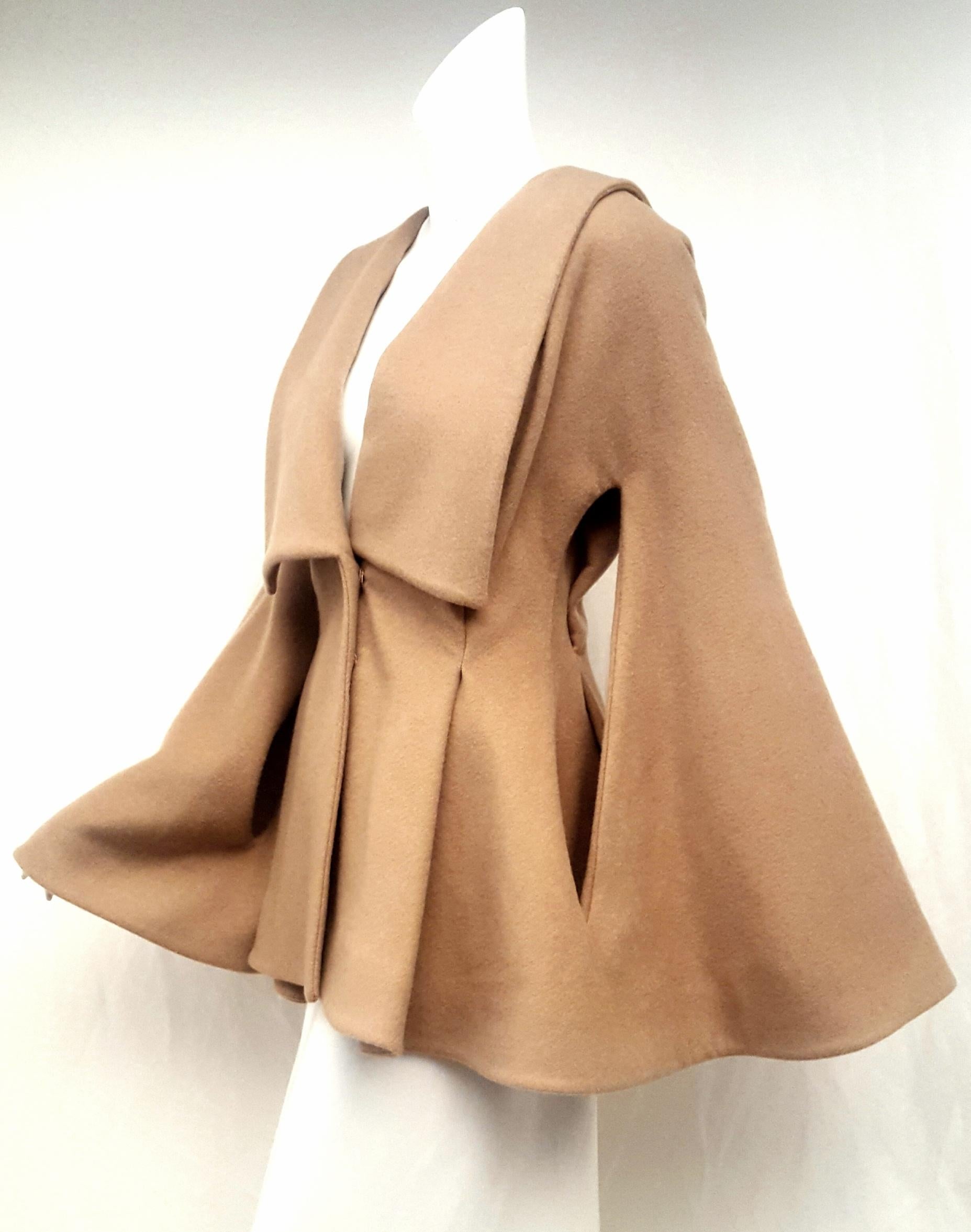 Alexander McQueen Camel hair jacket with shawl collar is gathered at the waist with wide pleats at front and back for that cinched and flared look.  Savile Row trained Alexander McQueen was a fashion visionary whose shows fused radical theatrics
