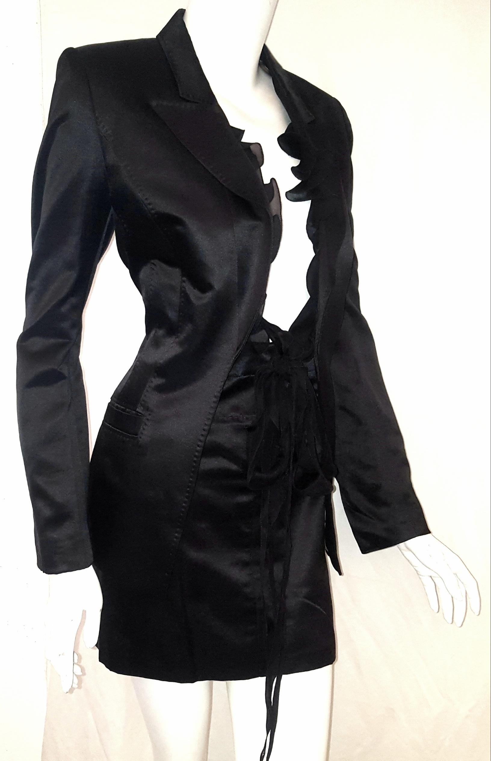 Roberto Cavalli black satin silk and cotton suit with silk ruffles that can be tied in a bow, for closure.  Features 5 concealed Roberto Cavalli buttons on each cuff.  Skirt has 2 hook and eye closures and one zipper at front.  Both pieces are lined