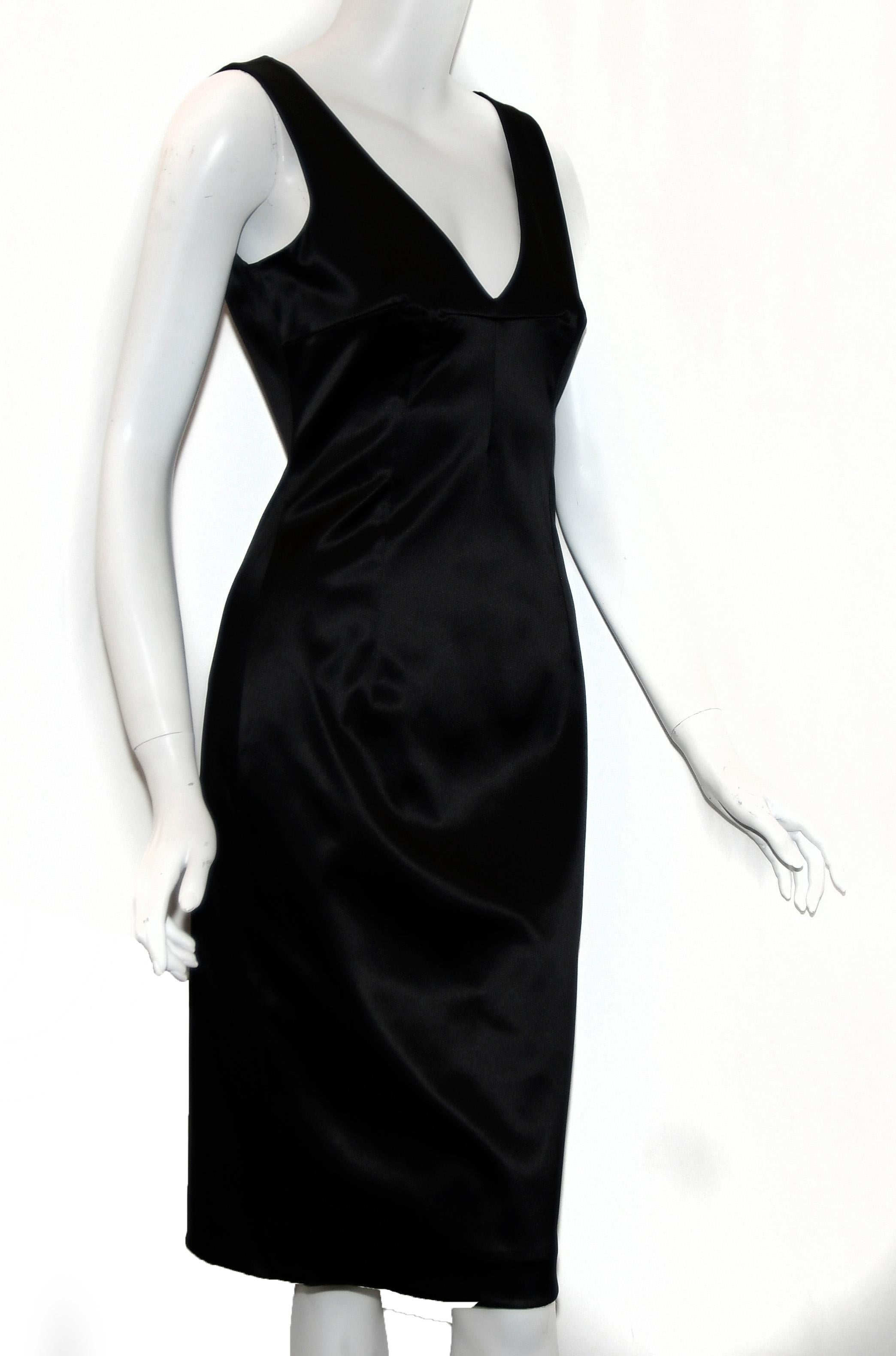Dolce & Gabbana black stretchy satin sleeveless dress contains a zipper at back for closure and a single vent, also, at back.  This dress is fully lined in a black satin .  The front  & back include curved darts from bustline to the hem and from the