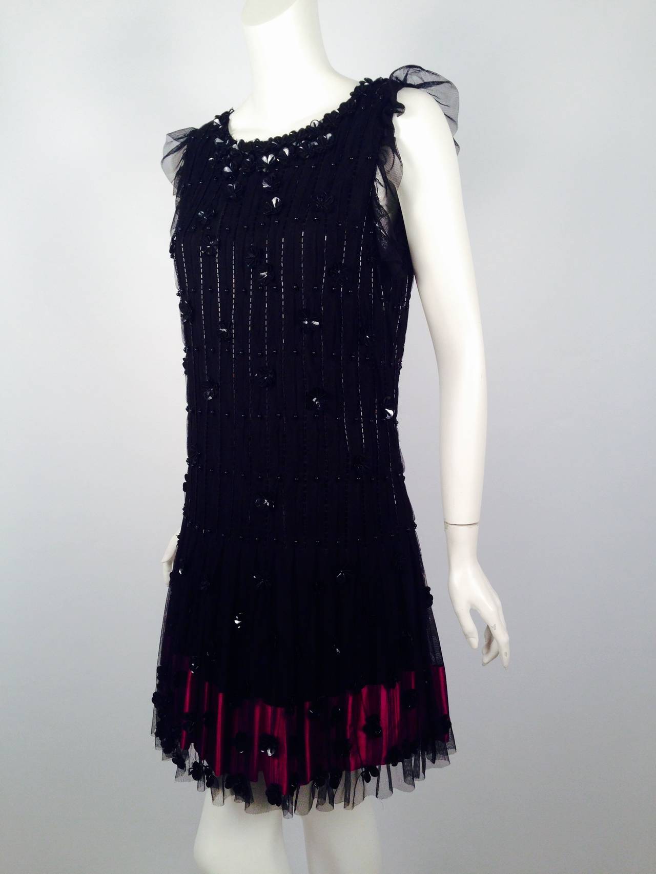 Dinner and dancing, anyone?  Brand New RED Valentino dress is a perfect choice for a night that will not soon be forgotten!  Various beads and floral paillettes shower the net overlay.  Slightly capped sleeves are created from flirtatious netting. 