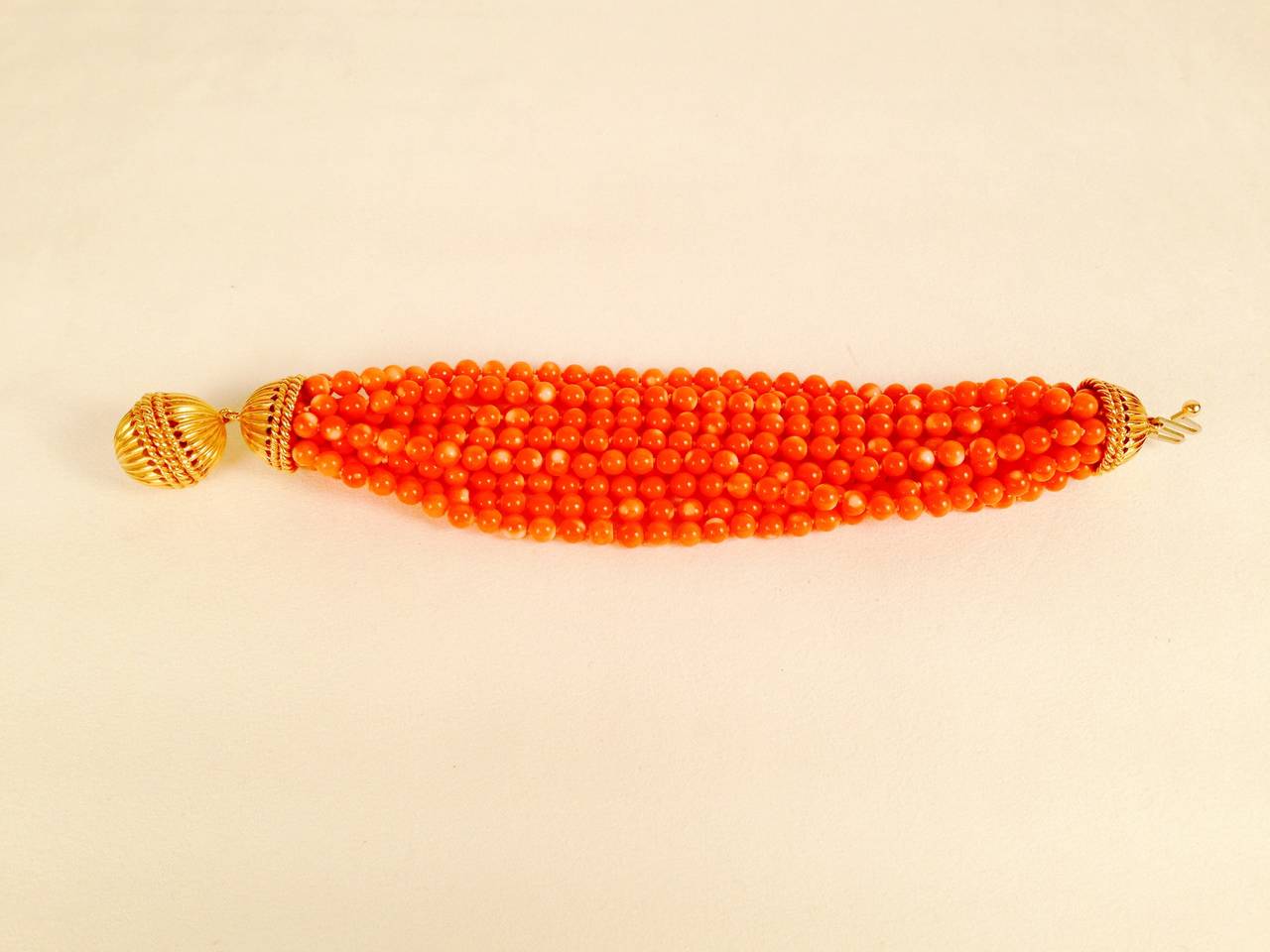 Multi-Strand Coral Bead Bracelet With Heavy Gold Clasp.  This bracelet may be twisted to form an unforgettable torsade!  Features 12 strands of coral ~ 5.5mm and a heavy 14 karat yellow gold clasp and end caps.  The bracelet is 9
