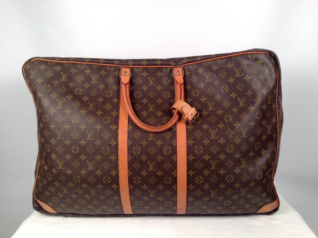 This Louis Vuitton Monogram Canvas Sirius 70 single compartment soft suitcase is the largest member of the Sirius family and will fit in the overhead cabin. This soft suitcase is constructed from Louis Vuitton's trademark, super-durable Monogram