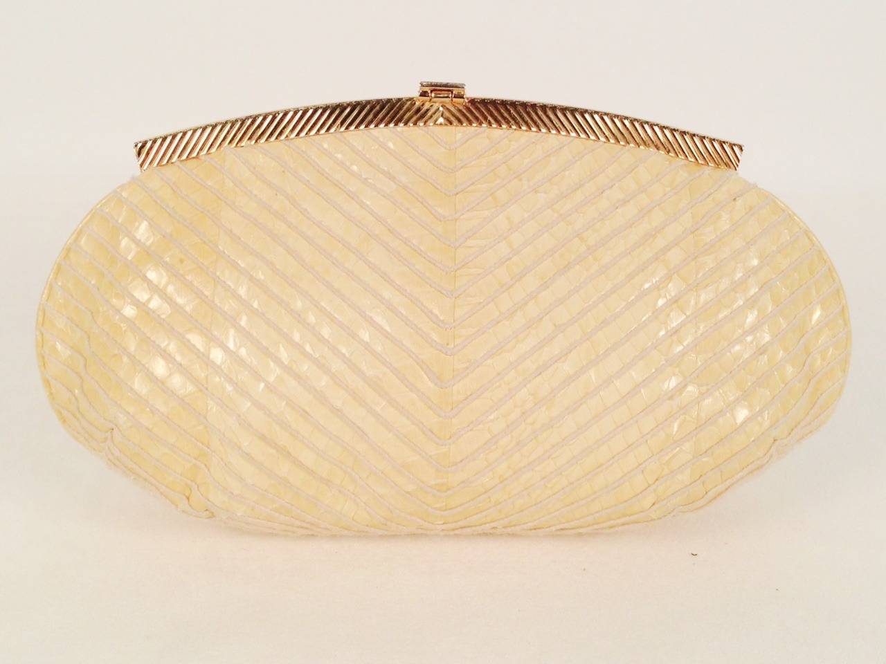 Vintage Python Convertible Clutch is highly desired by all collectors of Judith Leiber! Features slightly gathered, sumptuous lizard skin in a luscious shade of French Vanilla.  Gold tone chain converts from clutch to shoulder bag with minimal