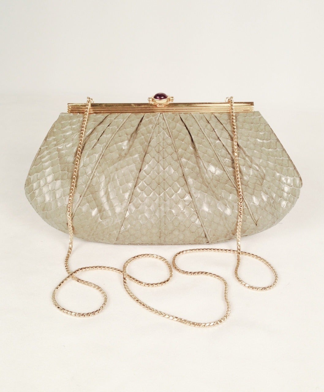 This vintage Judith Leiber bag is a must for any collector of all things Judith!  Fern green python is slightly gathered to create a definitively feminine silhouette.  Jeweled clasp features a cabochon amethyst with pink cabochon tourmaline ends. 
