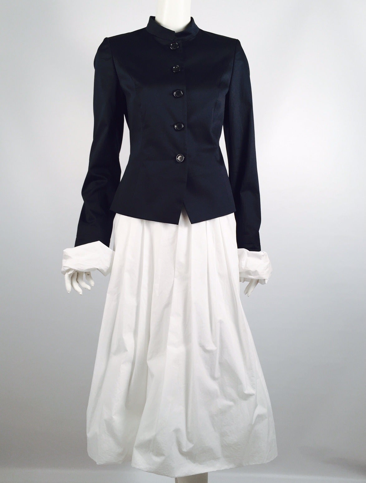 Pauw Navy and White Cotton Skirt Suit is true to the design sensibilities of the Netherlands!  Subtle, elegant, and deceptively simple design is the hallmark of this unforgettable ensemble.  Detachable white pouf collar and cuffs reveal a fitted