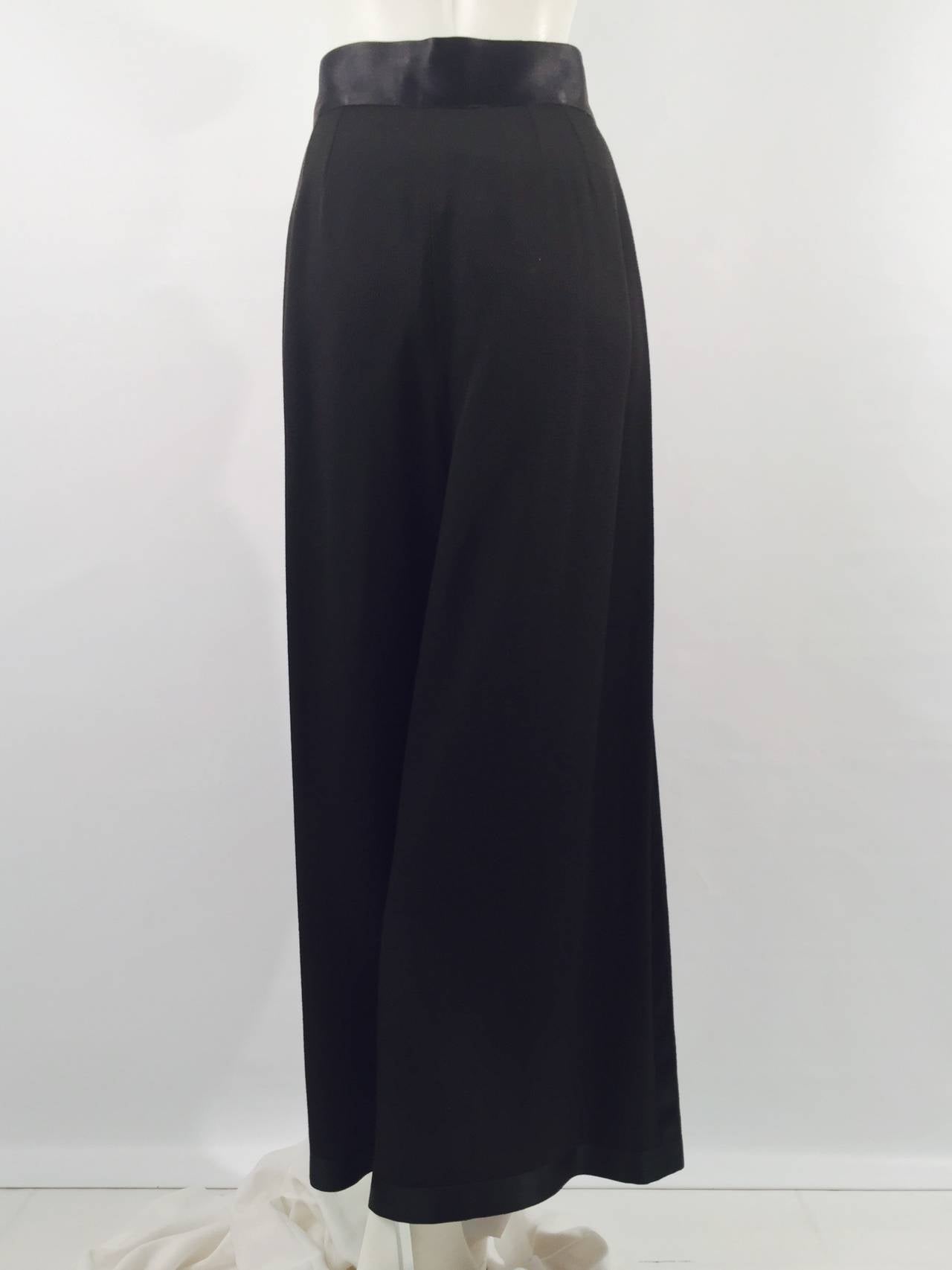 Chanel 1993 Spring Evening Palazzo Pants prove that Chanel is much more than the skirt suit!  Pleated, wide-leg pants feature satin waistband, piping, and hem.  Secured by side hidden zipper with two gold tone, signature double 