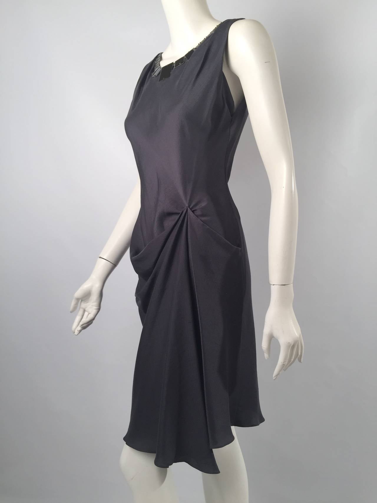 Sleeveless Dress With Metal Discs proves that Vera Wang makes more than beautiful wedding gowns!  Features exquisite 100% silk in graphite.  Body conscious, bias-cut, silhouette is draped and gathered on left side.  