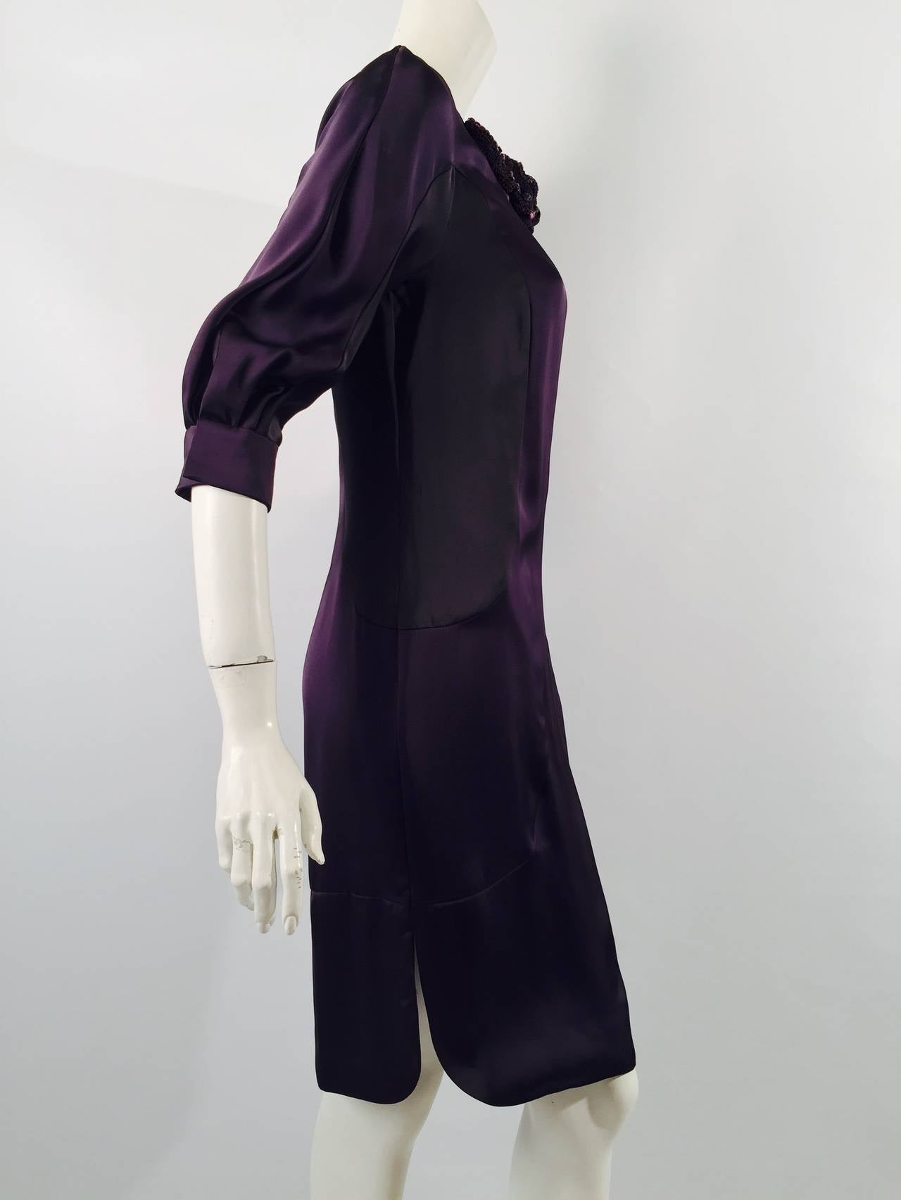 New Valentino Satin Color Block Shift is undeniably chic!  It's all in the details...ultra-luxurious satin, 100% silk lining, and classic design promise to make this a timeless favorite.  Features aubergine and black panels and raglan bracelet