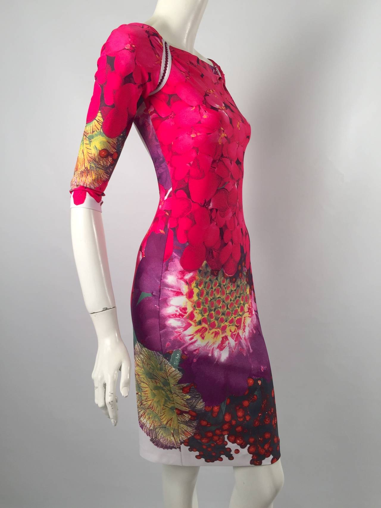 Brand New Wild Berry Print Dress is typically Roberto Cavalli!  Body conscious?  Of course!  Features stretch fabric with rich and colorful print.  Elbow length sleeves are attached to the body of the dress with knit detail.  The piece de