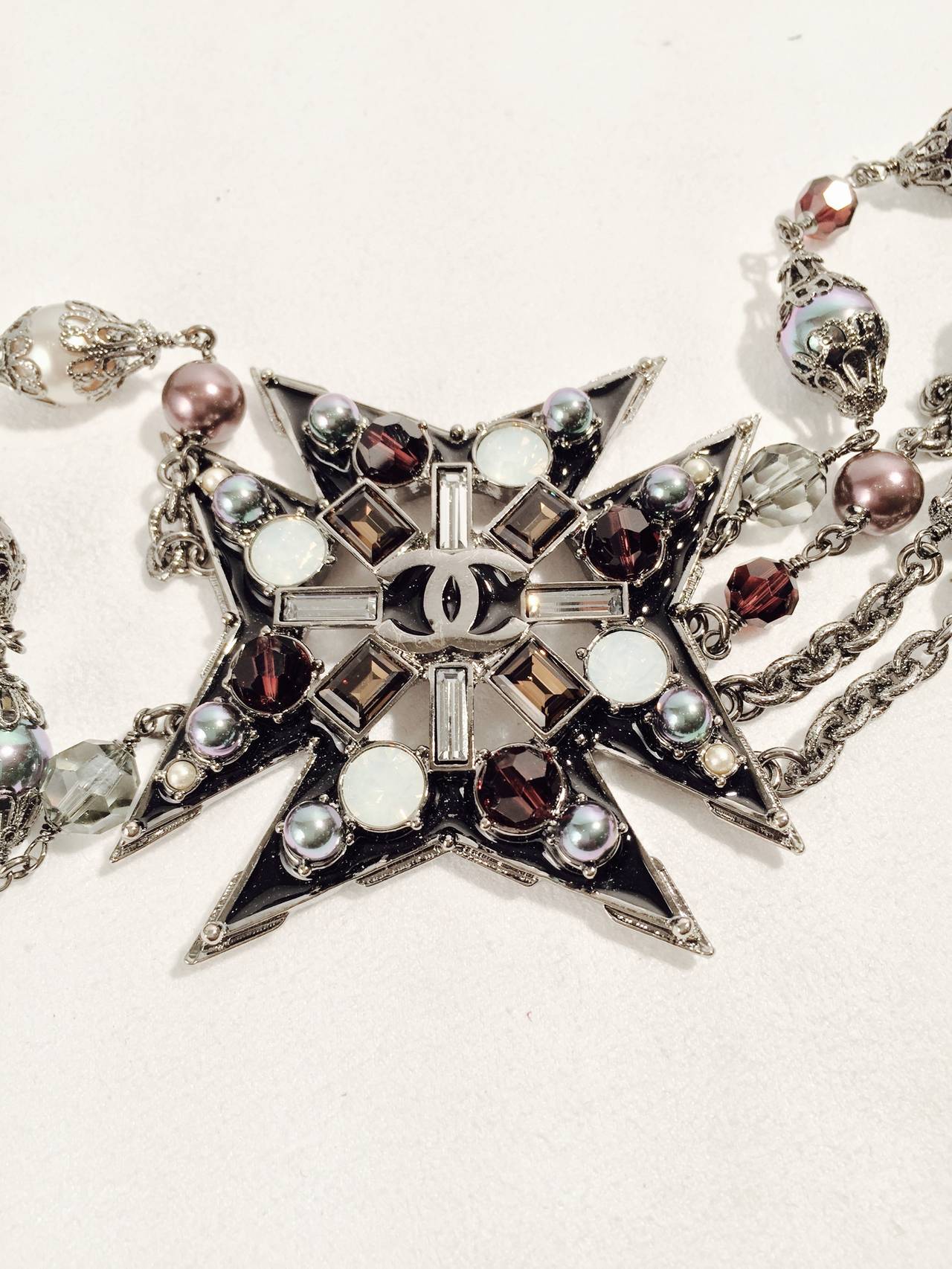 Distinctly Chanel piece is truly a remarkable find!  This wonderous design features two exquisite, bejeweled Maltese Crosses and a Gripoix double 