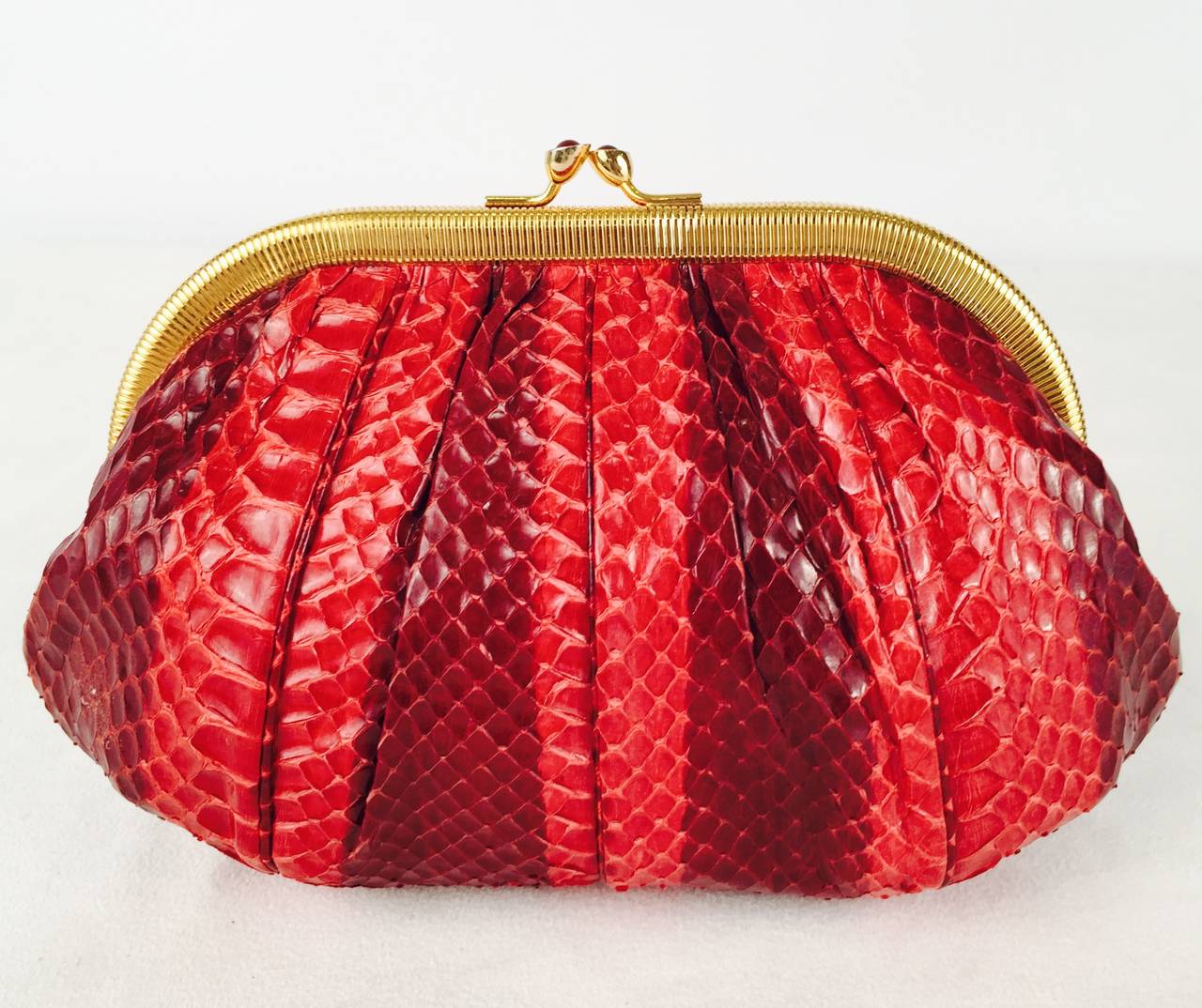 Judith Leiber Snakeskin Evening Bag is highly desired by all collectors of Judith Leiber! Features butter-soft snakeskin in luxurious bands of burgundy and red berry.  Easily converts from clutch to shoulder bag with minimal effort!  Gathered design