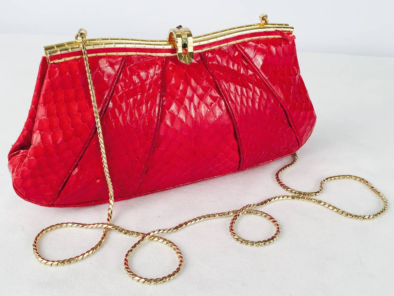 Judith Leiber Red Snakeskin Evening Bag is highly desired by all collectors of Judith Leiber! Features butter-soft snakeskin and easily converts from clutch to shoulder bag with minimal effort!  Gathered design accommodates more items as necessary.