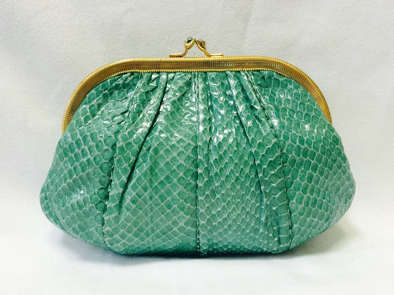 Judith Leiber Python Evening Bag is highly desired by all collectors of Judith Leiber! Features butter-soft snakeskin in luxurious glorious Ocean Green. Easily converts from clutch to shoulder bag with minimal effort! Gathered design accommodates