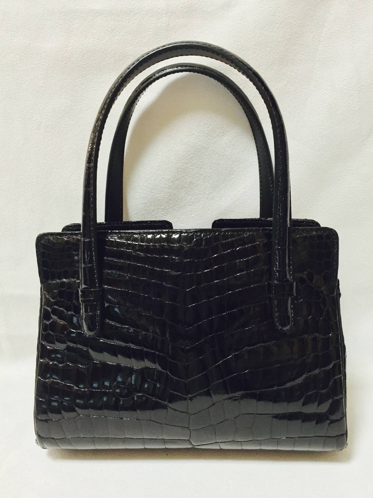Luxurious 1950s Vintage Gucci Alligator Satchel With Crystals shows why this house has been on the forefront of fashion for almost a century!  Perfect for a lady, this handbag features three compartments.  The center compartment is framed and