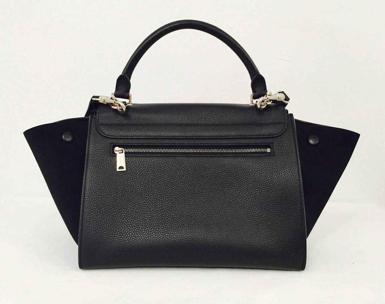 Coveted Céline Mini Trapeze Bag in Black is lovingly carried by some of the world's most stylish women!  This new classic shape is easily recognized from Hollywood to Bollywood and all points in between.  Features grained leather, full frontal flap