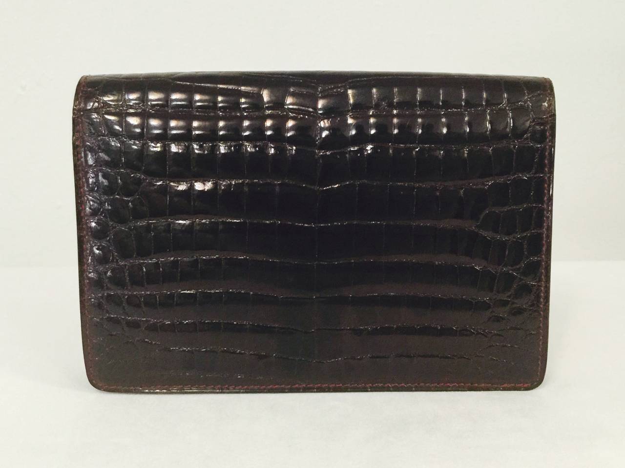 Vintage Balenciaga Burgundy Baby Crocodile Convertible Clutch is an ode to the traditions of the Parisian haute couture houses.  Considered by Diana Vreeland as the very best of the best couturiers, Cristobal Balenciaga was responsible for some of