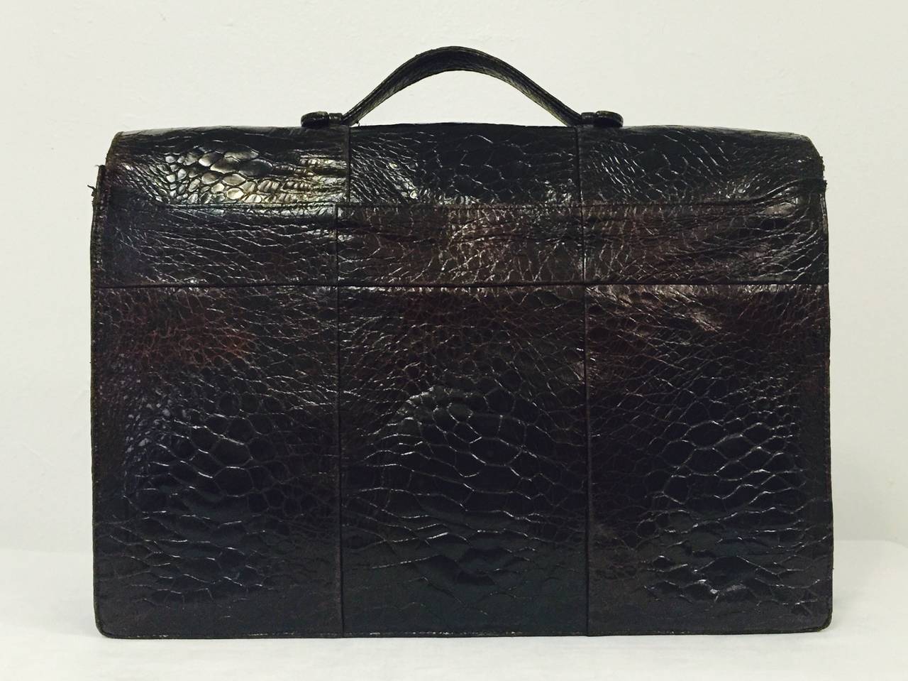 Exotic Vintage Attache is an ode to Old World craftsmanship and worthy of any executive or diplomat!  Crafted from only the most luxurious brown alligator, bag features one exterior pocket, three open interior compartments and one zippered interior