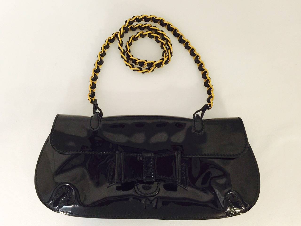 Patent Leather Shoulder Bag With Woven Chain Strap is decidedly Valentino!  Feminine, flirty?  But of course!  Features sumptuous black patent leather, snap closure and iconic luxurious bow on the front.  Black patent woven chain strap is the