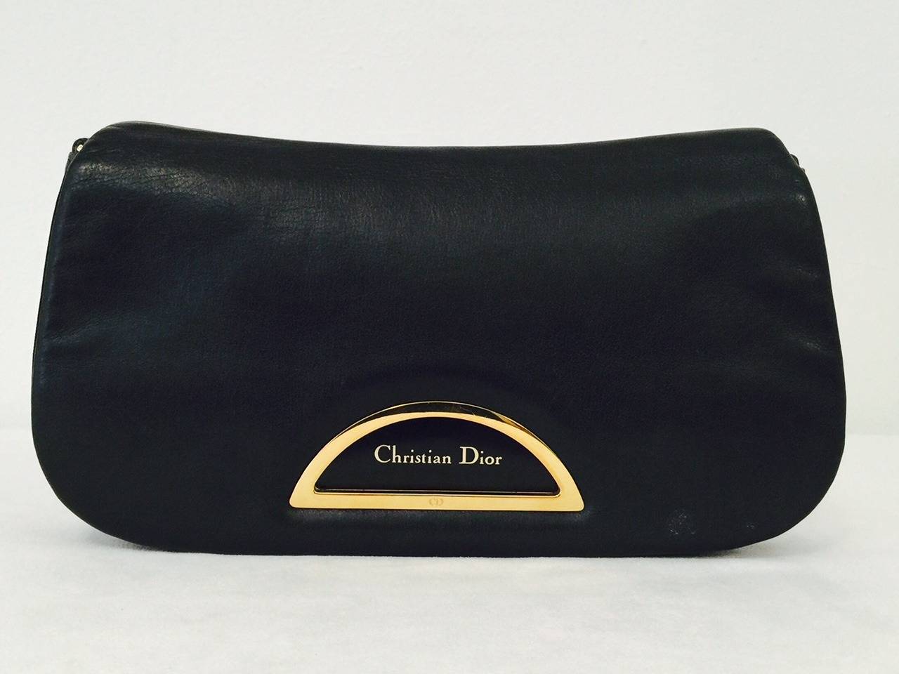 Christian Dior Shoulder Bag is quintessentially feminine and chic!  Features butter soft lambskin leather, gold tone hardware, adjustable strap, and magnetic closure!  Fully lined in luxurious black fabric.  Interior features one zippered flat