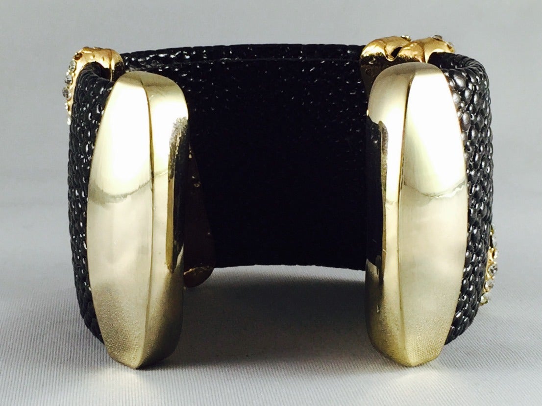 Black Shagreen Cuff is exotic, feminine and alluring! Features rugged, yet sophisticated shagreen leather and four gold tone pointed stations set with exquisite pave Swarovski Zirconia.  Open ends are slightly flexible and and easily accommodates 