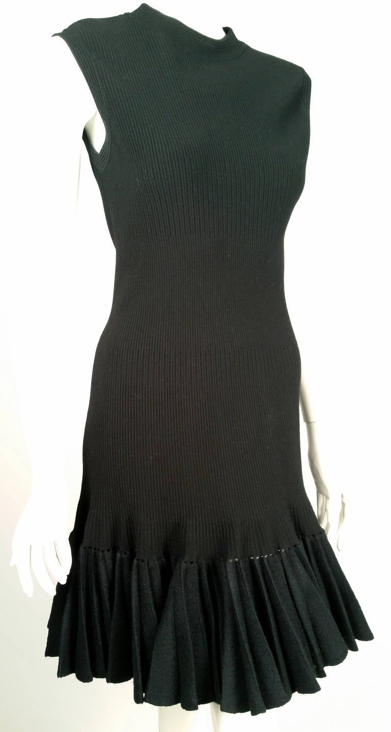 Known as the “king of Cling”, Azzedine Alaia’s creations are celebrated worldwide.  Sleeveless knit dress has round neck and banded arm holes.  Wool felt knife-pleated hem is elegantly suspended from the body of the dress using advanced techniques.