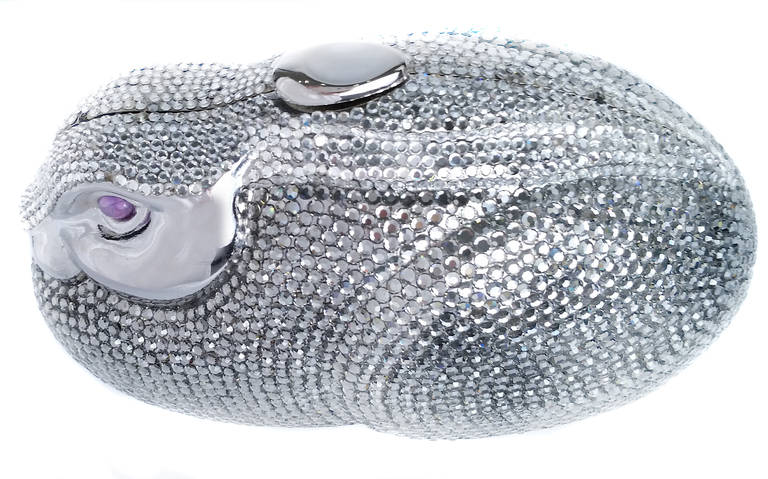 Absolutely divine Leiber classic rabbit evening clutch features the most exquisite amethyst cabochon eyes!  From the late 1970's, this bag is a must-have for any collector of minaudieres.  Features clear Swarovski crystals, silver metal frame with