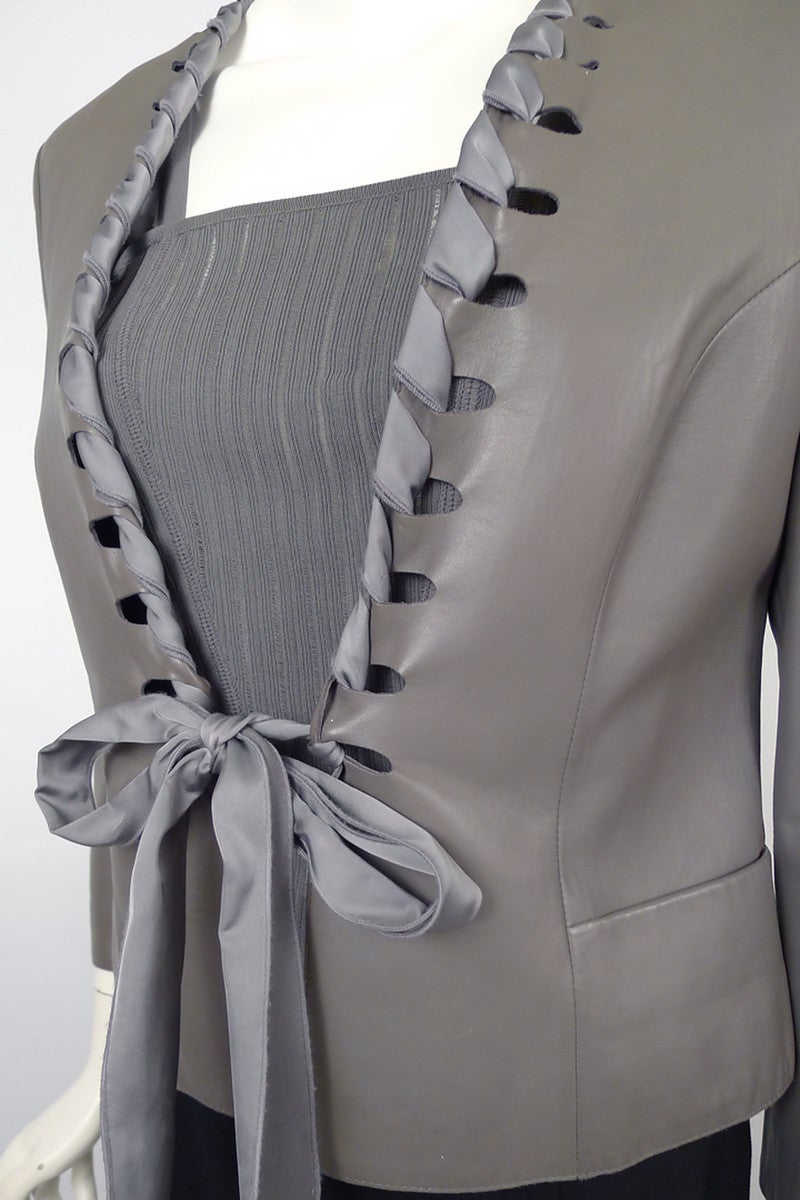 Eye-catching lambskin jacket and camisole ensemble by the master of Italian simplicity and sophistication, Giorgio Armani!  Dove Grey Jacket features feminine ribbon closure that has been artfully twisted and woven into the leather as a collar and