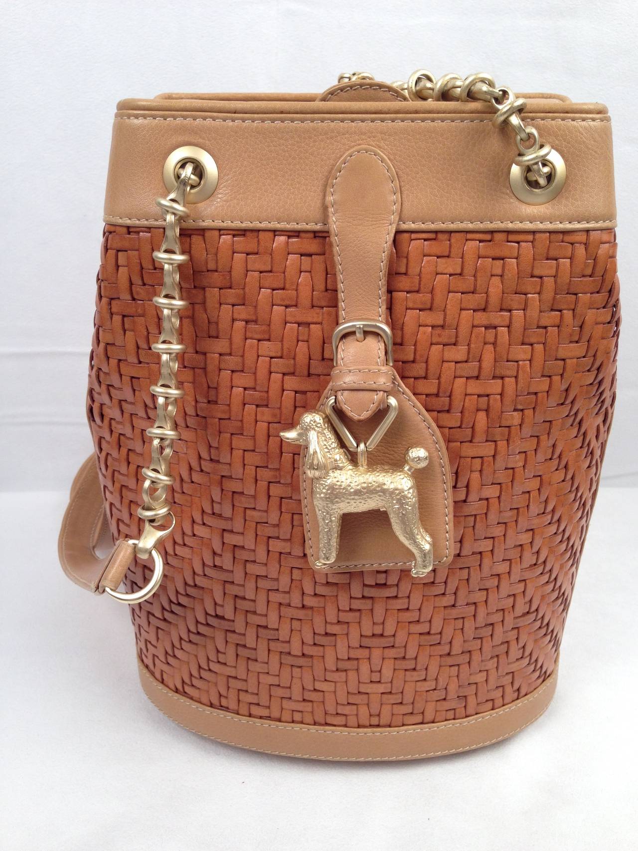 Barry Kieselstein-Cord sure could jazz up walking the dog!  This utterly charming and whimsical shoulder bag is made from the finest Italian high-quality woven caramel leather and trimmed with sturdy Italian beige saddle leather.  The satin